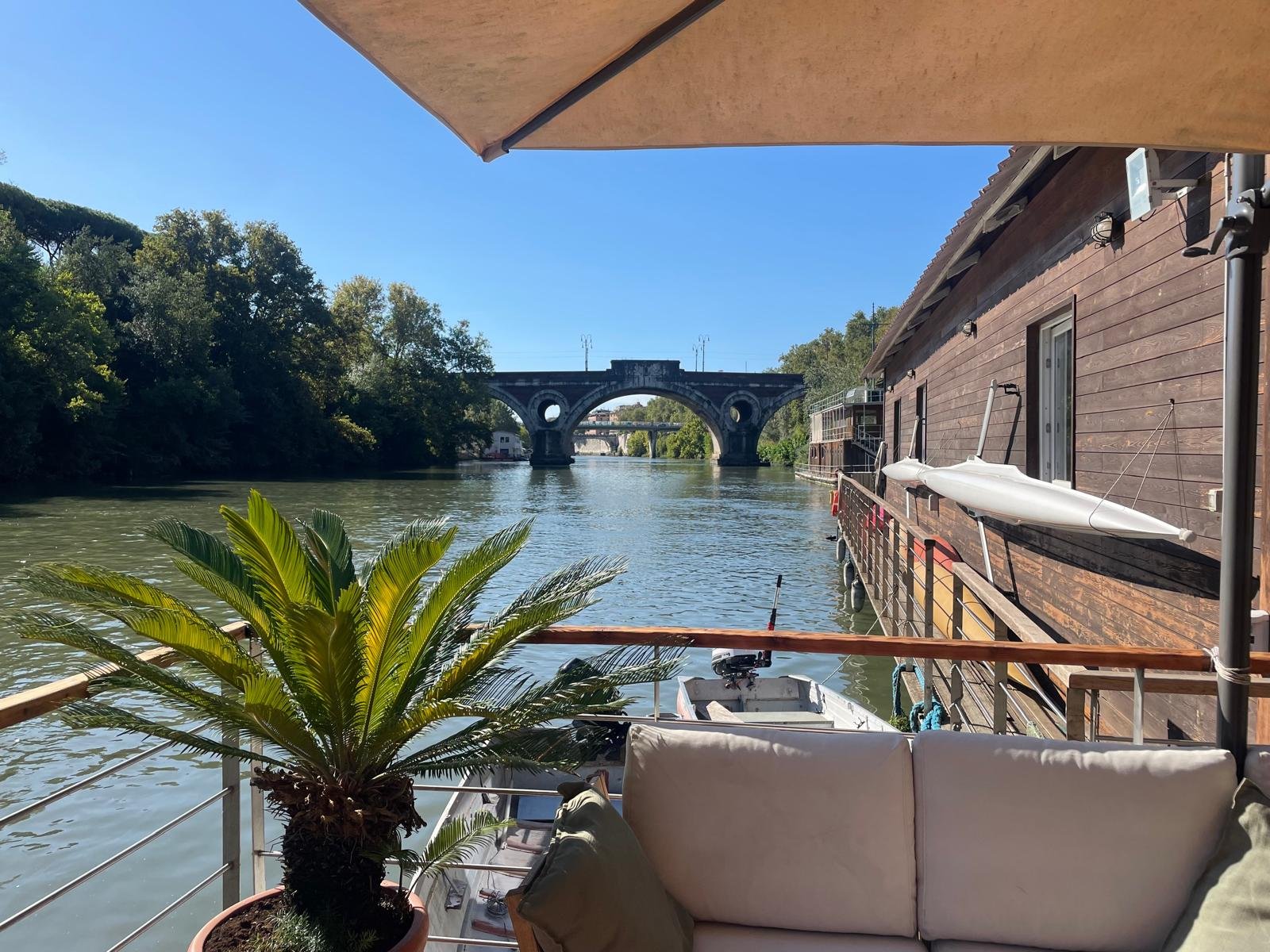 View of the Tiber and stone bridge from the rowing club terrace in Rome