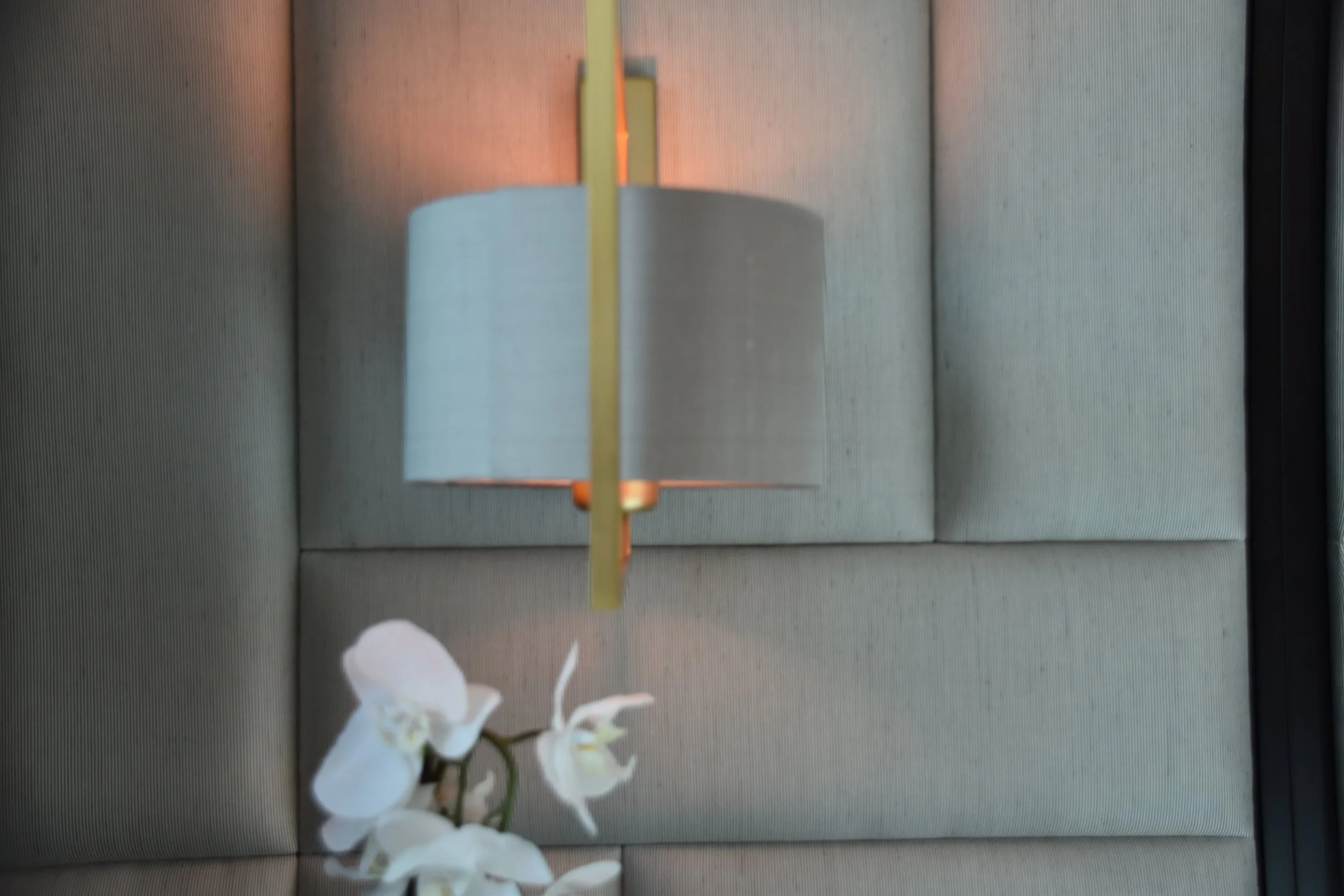 View of a wall light on an upholstered headboard