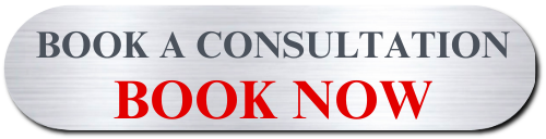 A metallic sign with rounded edges displaying the message 'Book a Consultation, Book Now' in black and red text.