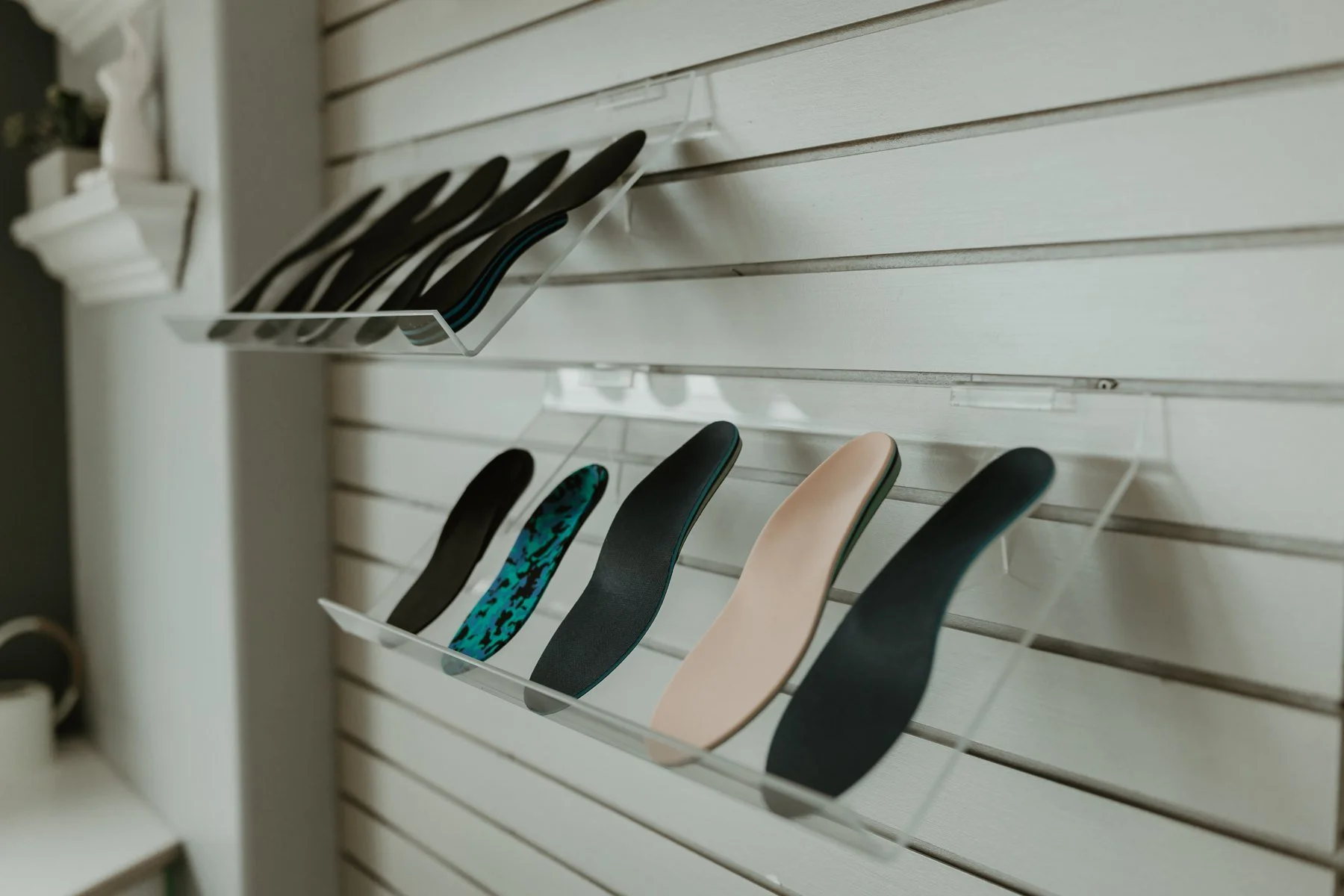 Custom orthotic insoles displayed in the Stride clinic in Valley East