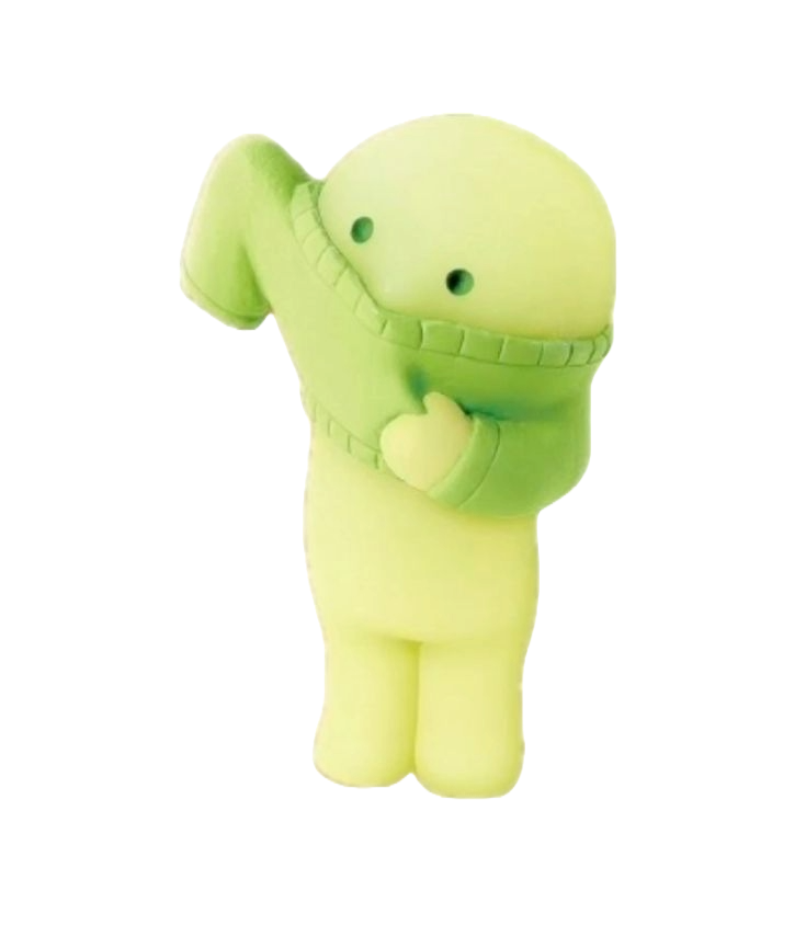 Light green plush toy character with a round head, small black eyes, smiling mouth, and a hand on its chest, standing against a black background.