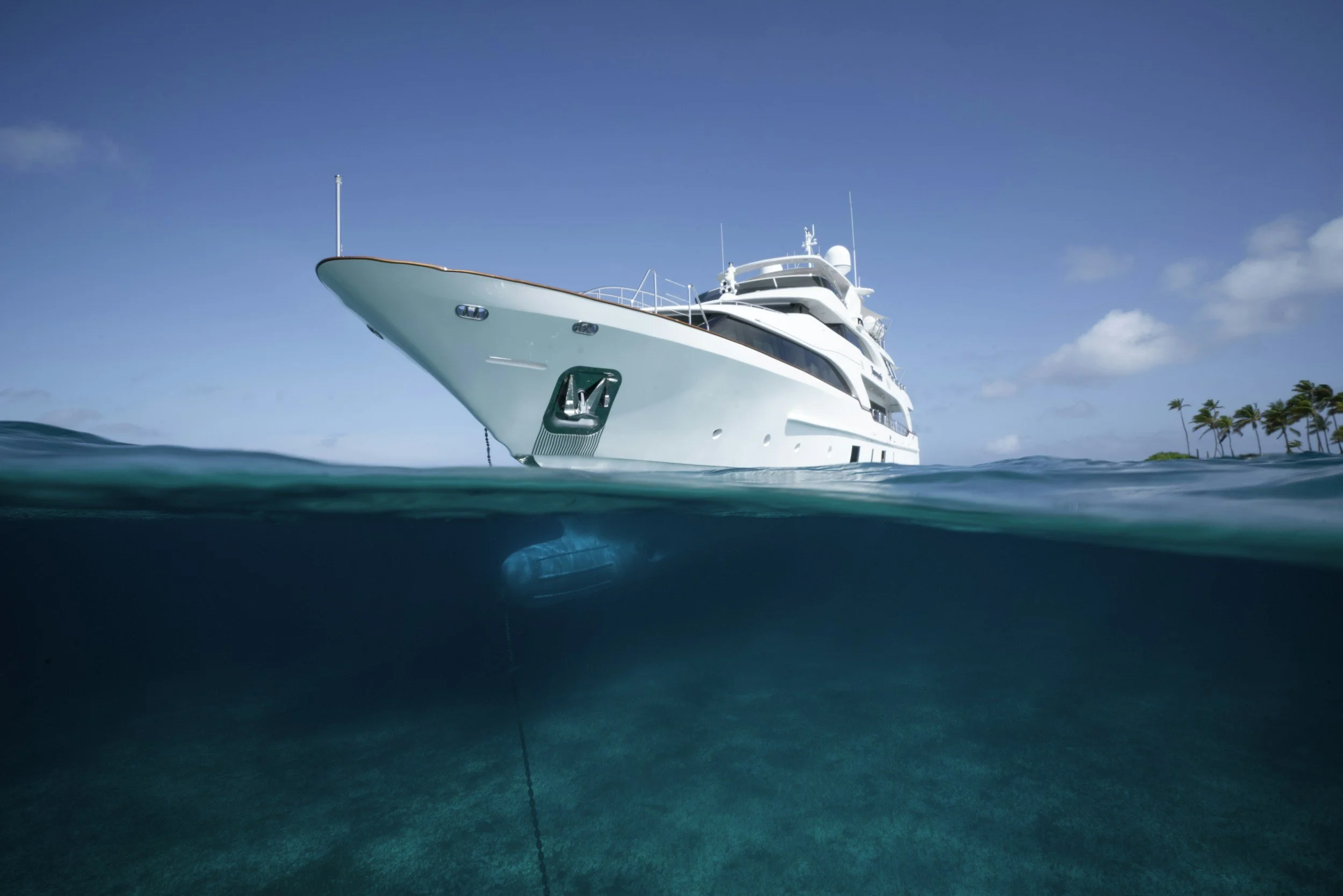 A large white yacht floating on the water