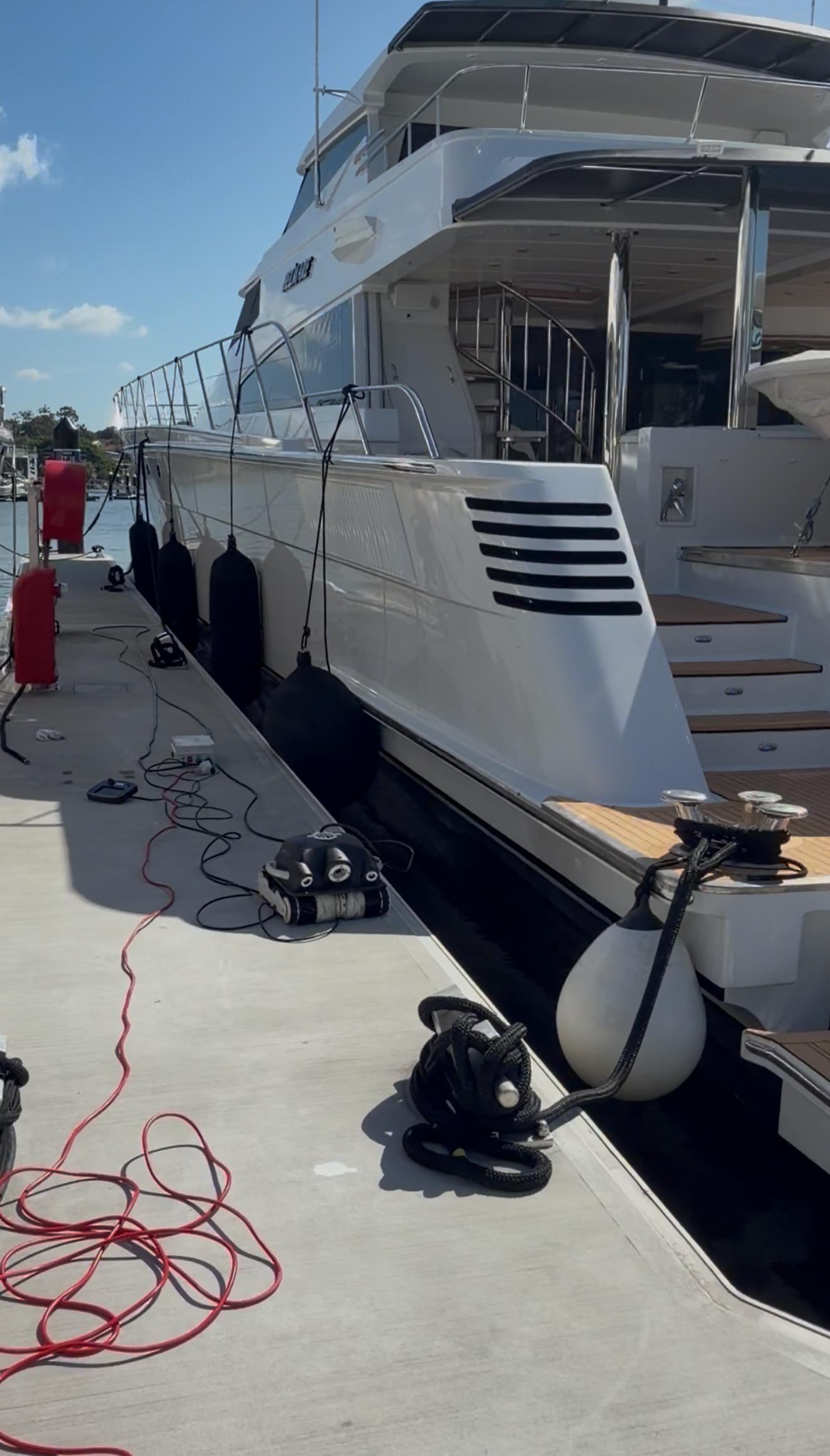 A yacht docked at a marina after underwater hull cleaning in Sunshine Coast