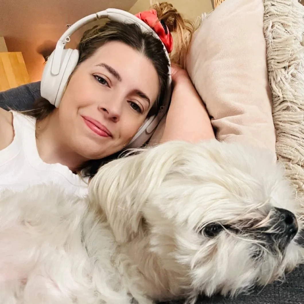 Natalie and Falcor, her dog, relaxing on a sofa