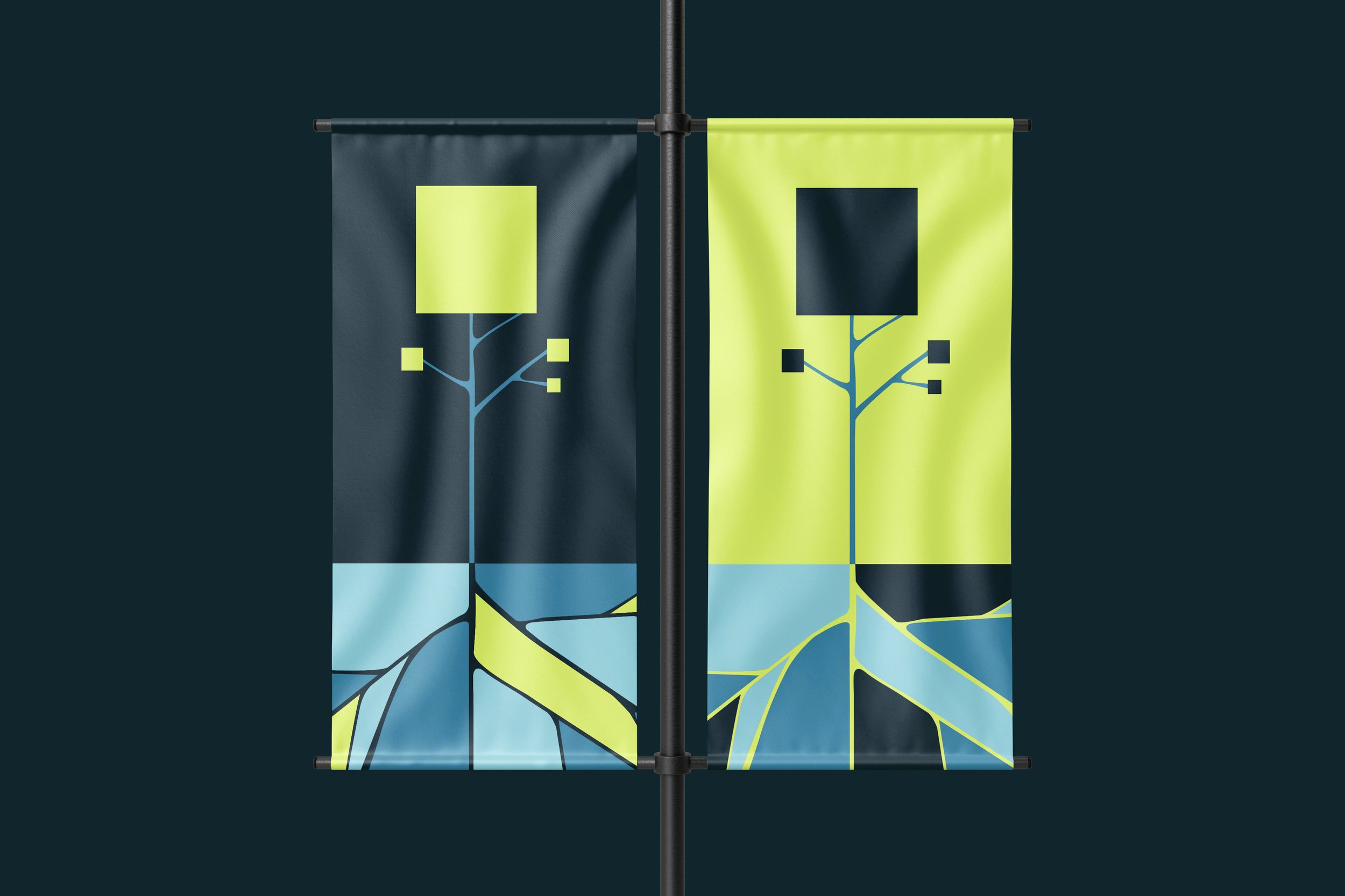 Deux drapeaux avec un motif de branche d'arbre stylisée, l'un foncé avec des branches vertes et l'autre jaune avec des branches bleues, flottant en face arrière d'un fond sombre.