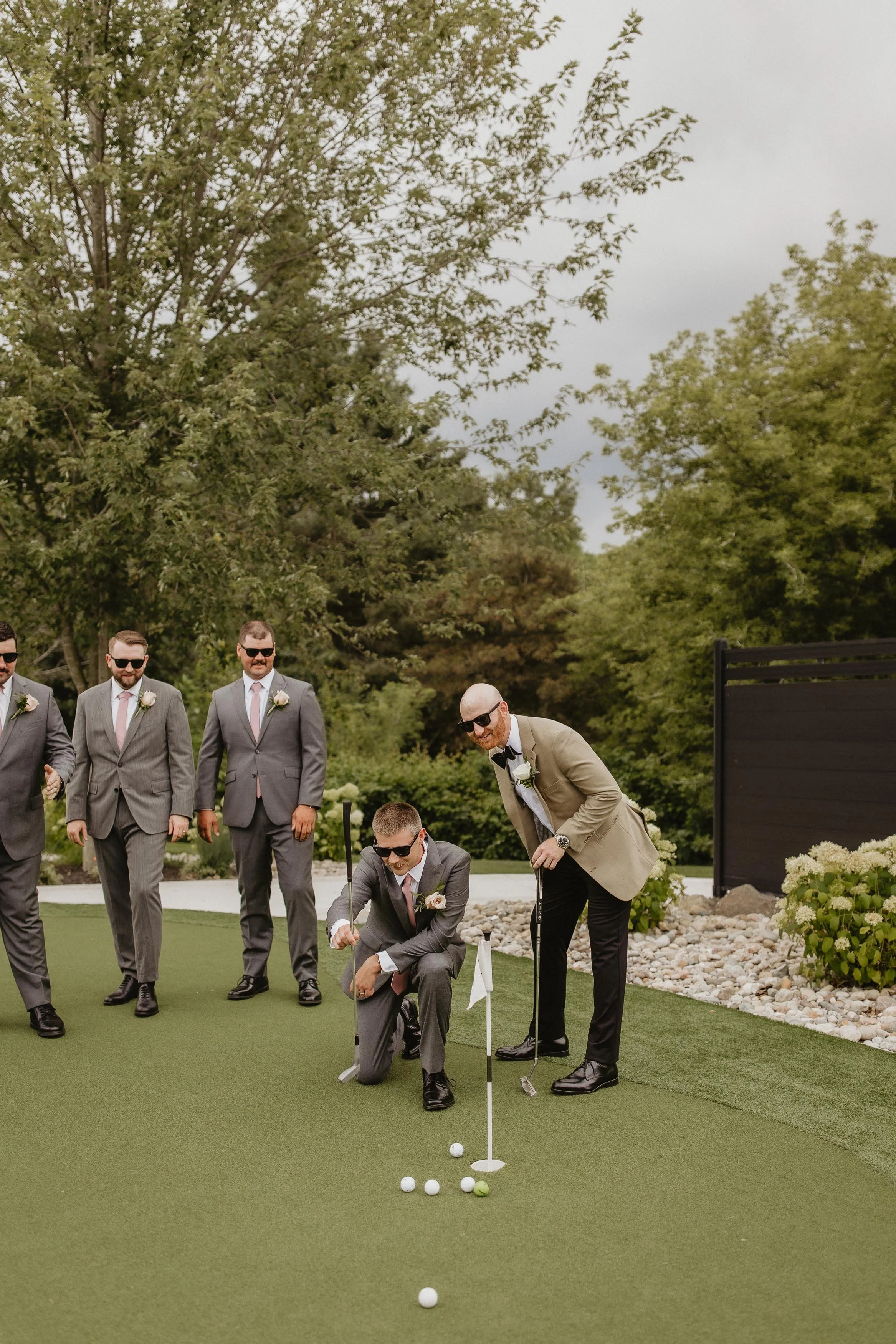 groom's party playing golf on the putting green