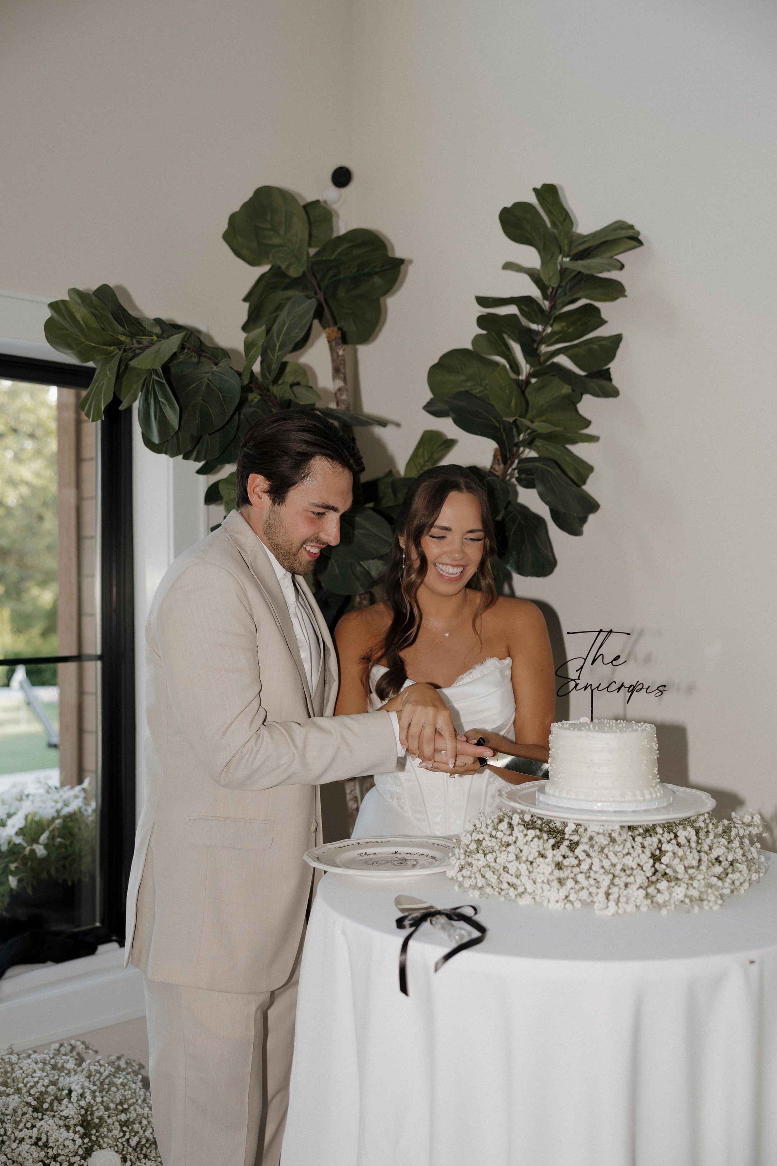 bride and groom cutting into their wedding cake