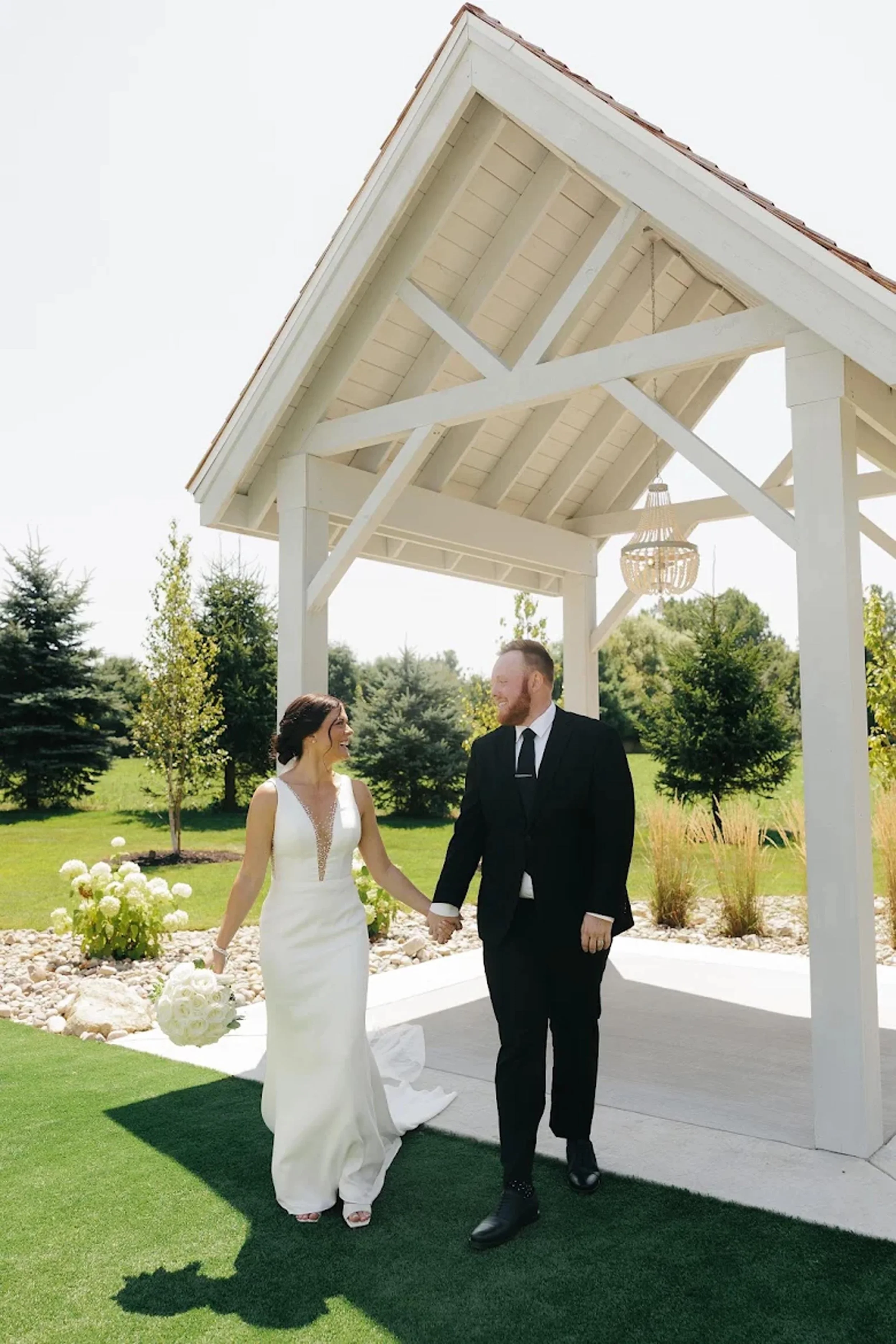 couple holding hands under the open-air chapel