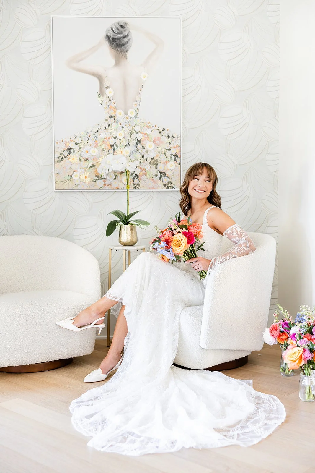 bride looking down at her dress in the bridal suite doorway