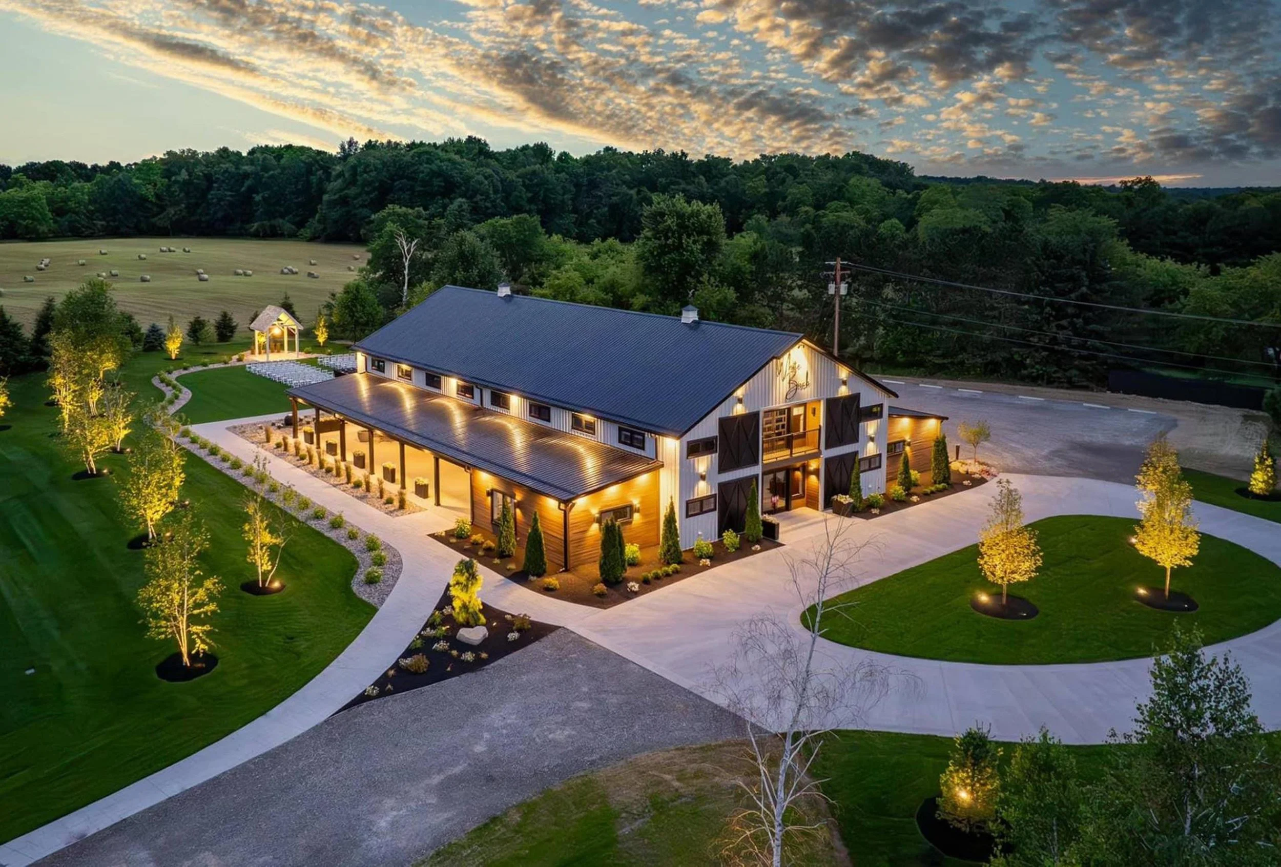 aerial shot of the barn and property, lit up at night