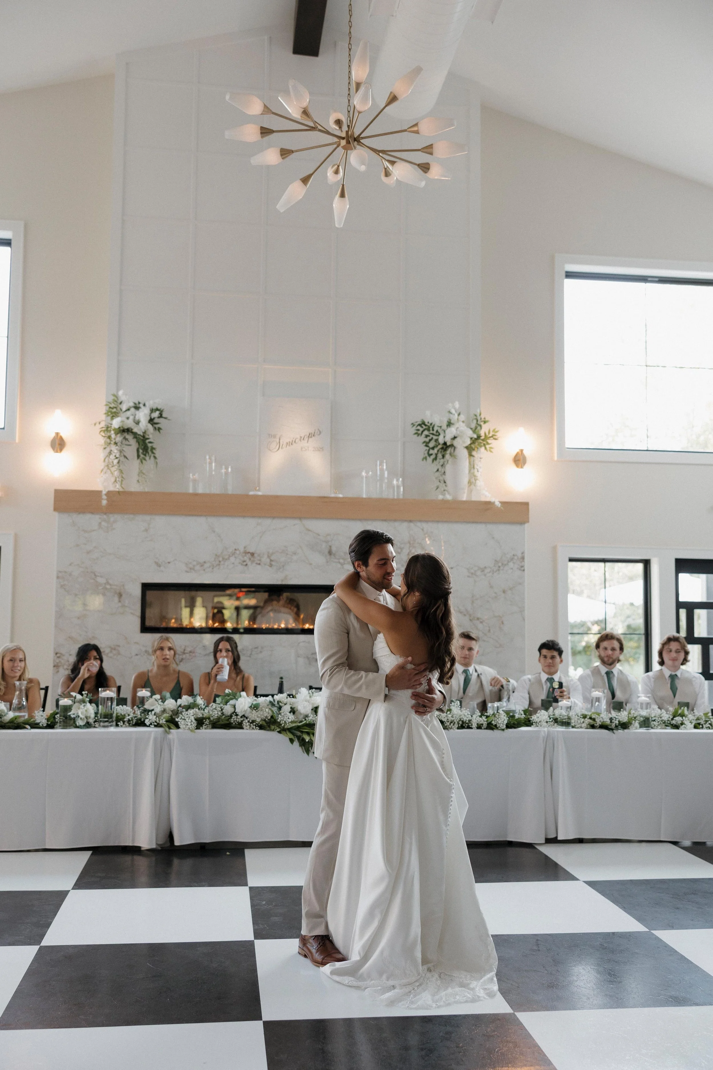 bride and groom dancing on the black and white checkered dance floor