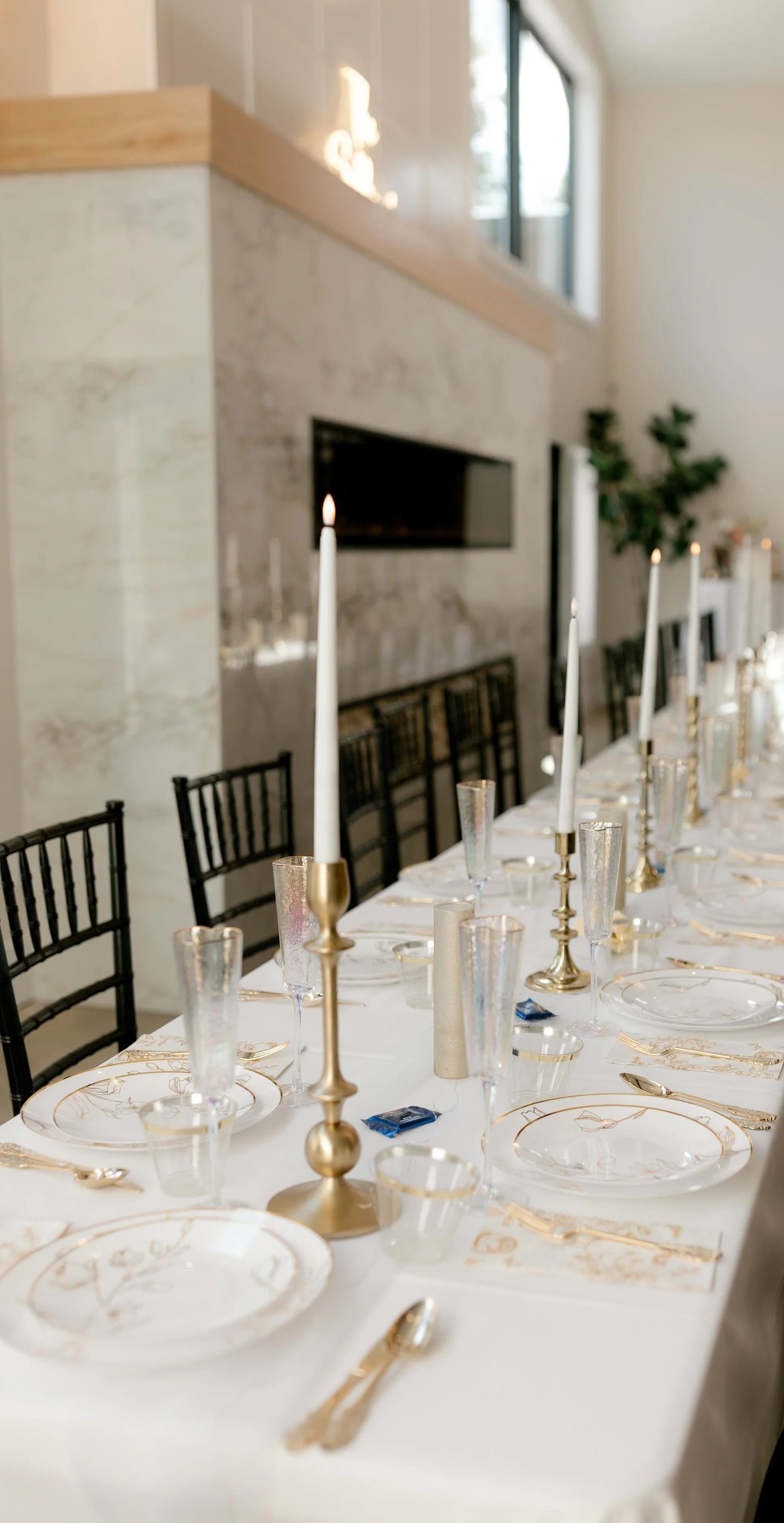 head table set up with candle sticks and white linens