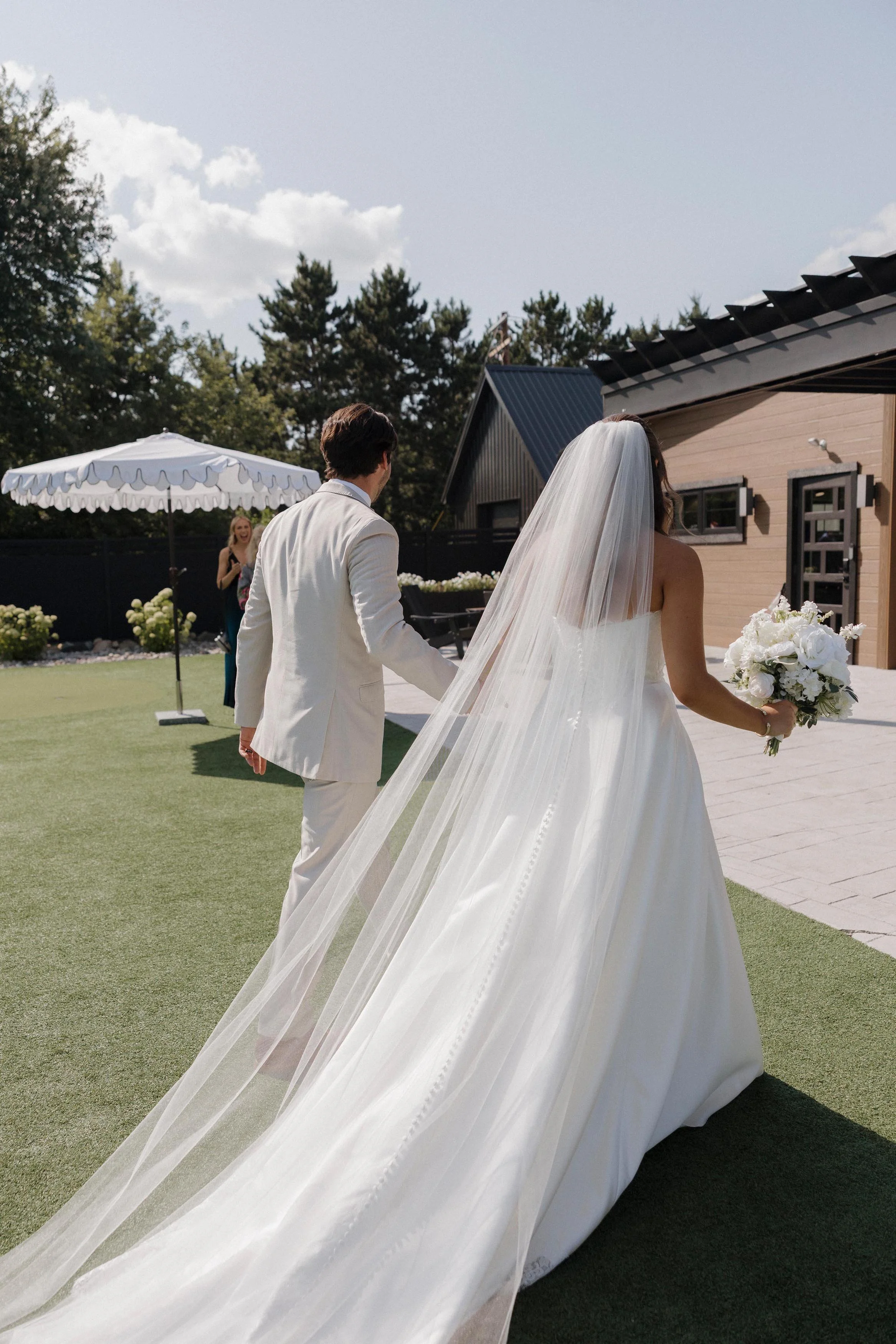 bride and groom holding hands, walking in the outdoor space