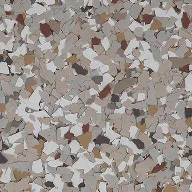 Close-up of a speckled patterned surface with small, irregularly shaped pieces in white, beige, brown, and gray colors.