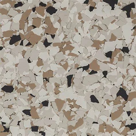 Close-up of scattered black, white, and tan rubber fragments.