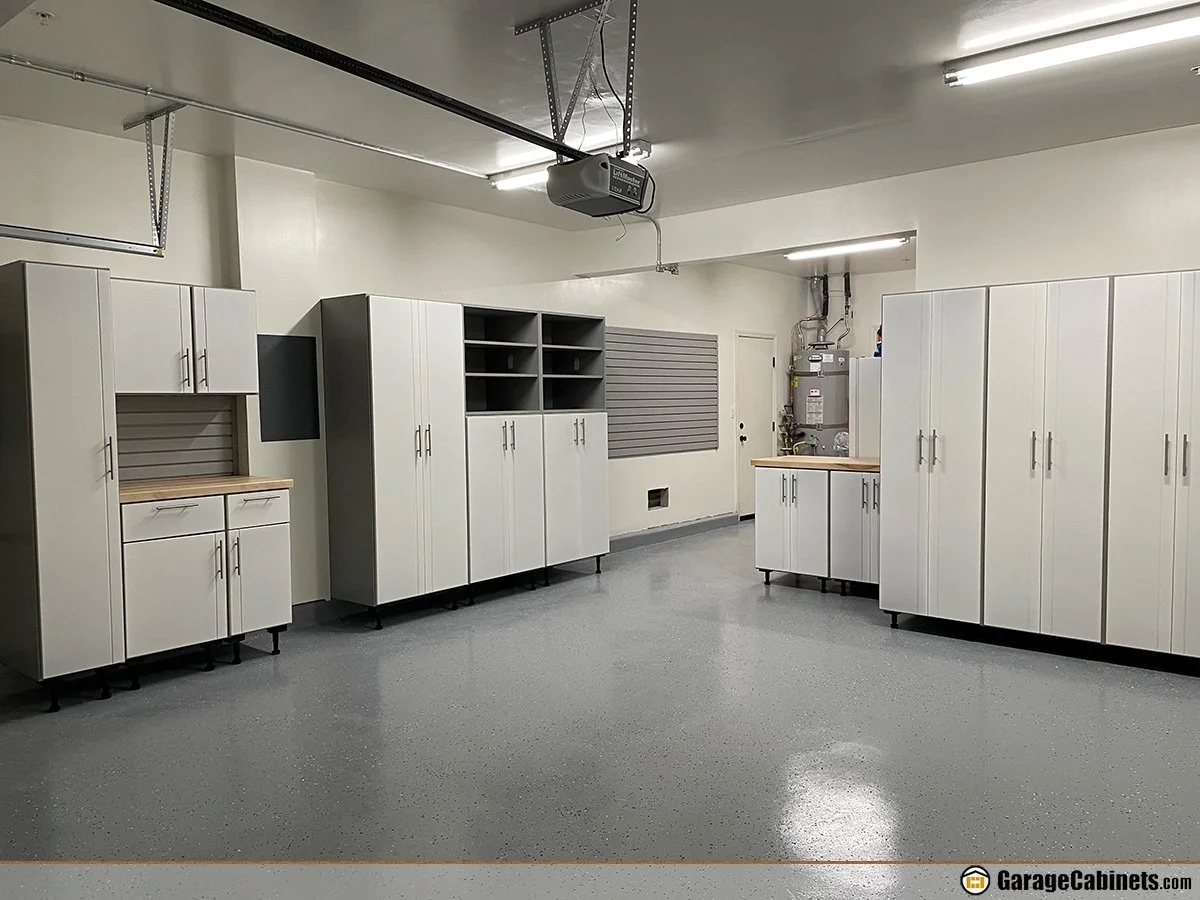 Clean, organized garage with epoxy floowr and custom cabinets.