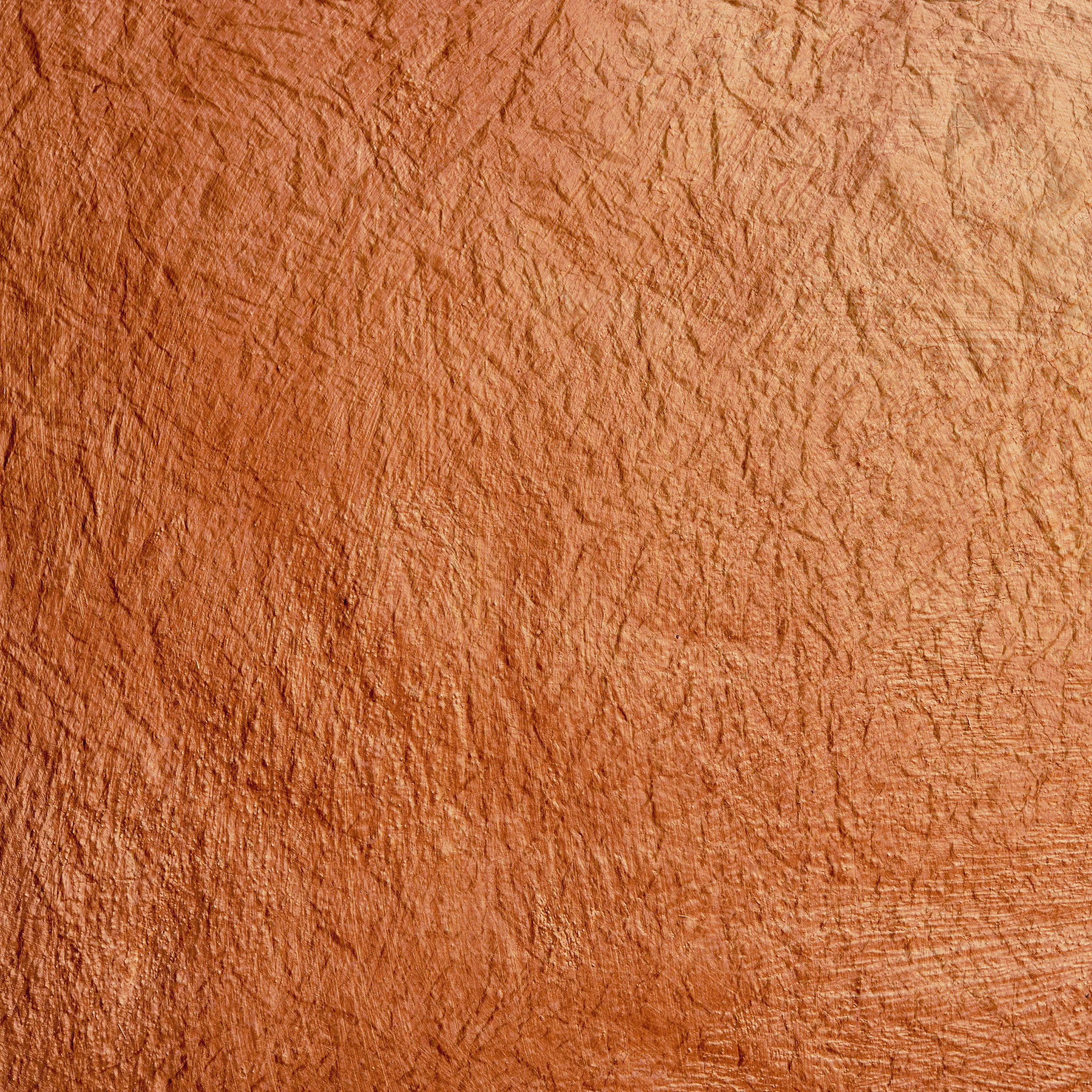 Texture de mur en terre cuite de couleur orange.