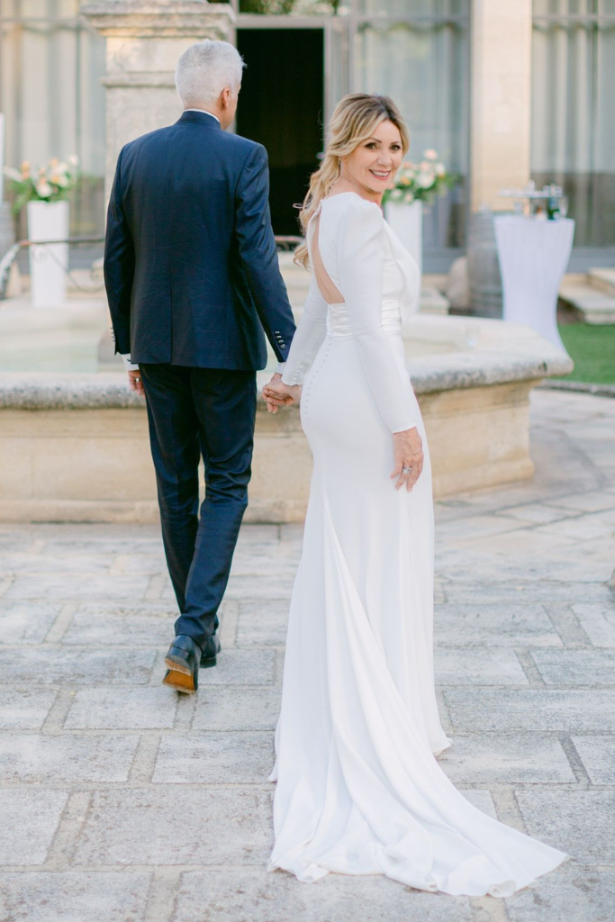 Une femme en robe de mariée et un homme en costume de mariage dans un jardin lors d'un mariage.