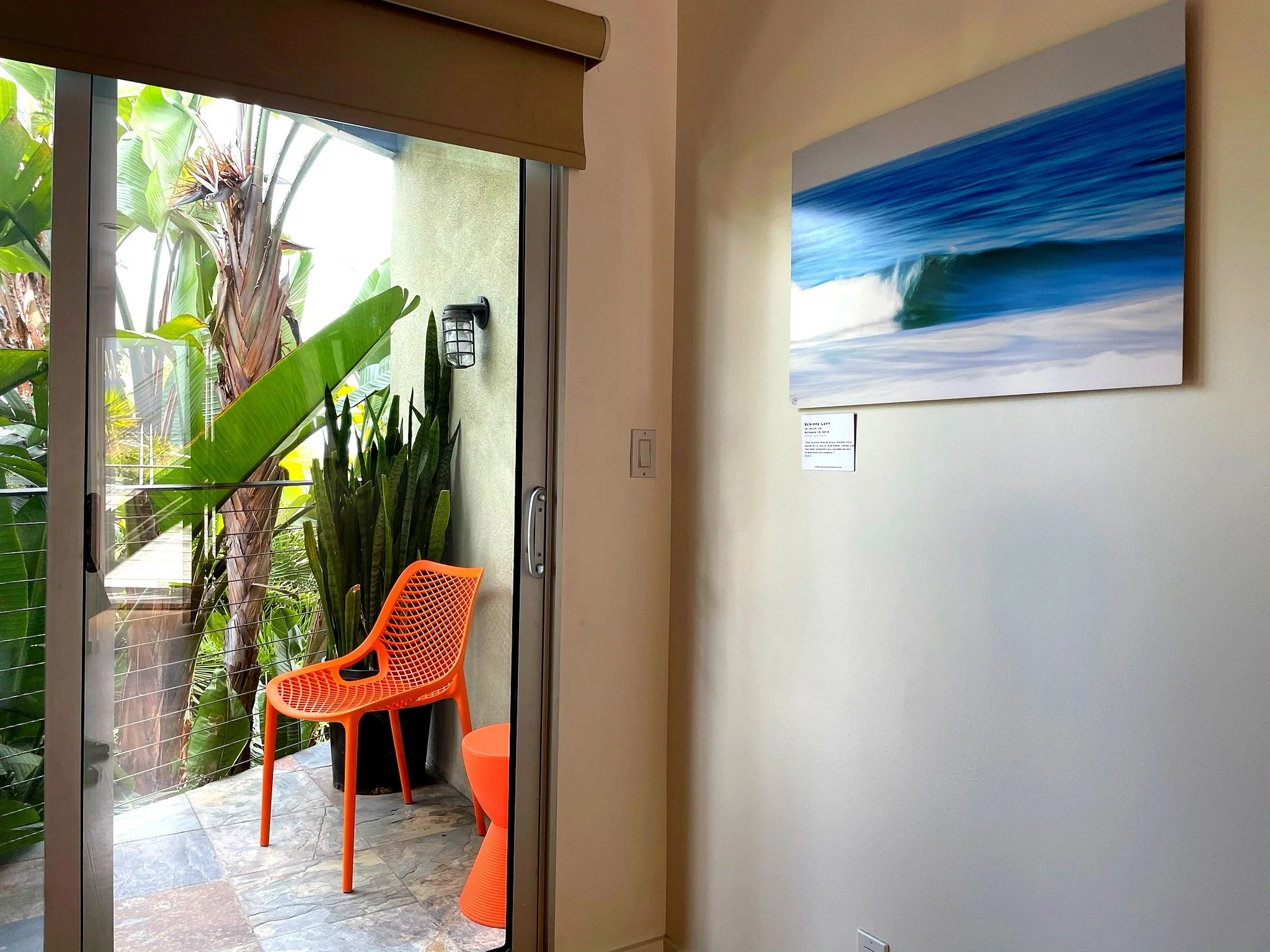 Room interior with private balcony and surf photography art at The Malibu Motel Malibu CA