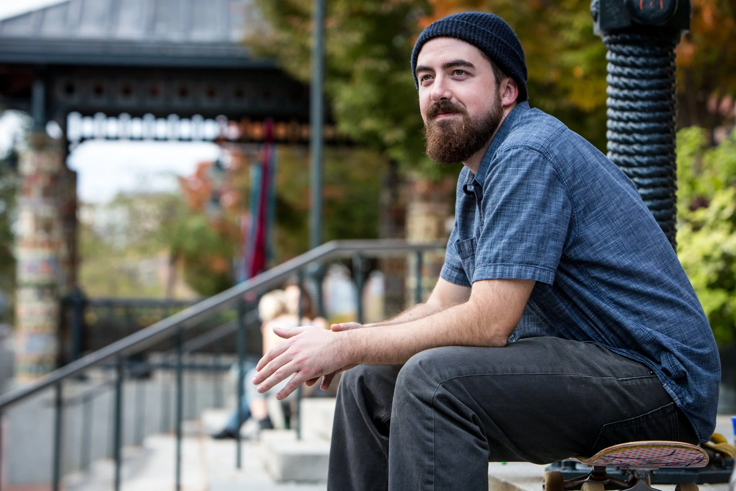 young man with a beard looking contemplative