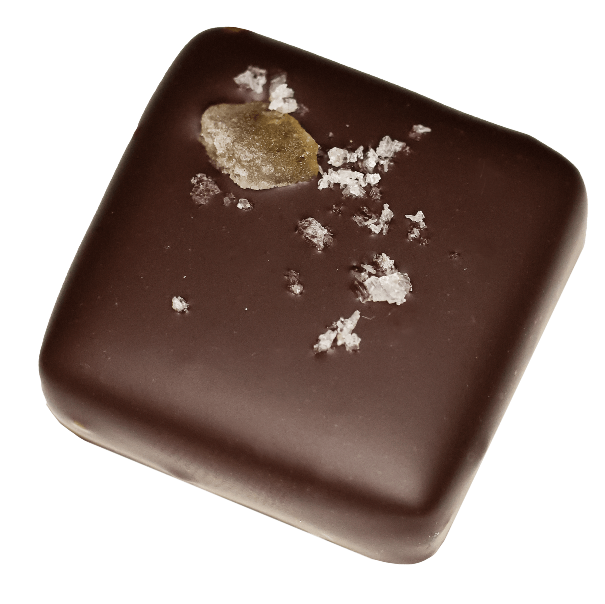 Close-up of a rectangular chocolate candy with a smooth surface, topped with a small piece of beige caramel and sprinkled with coarse salt.