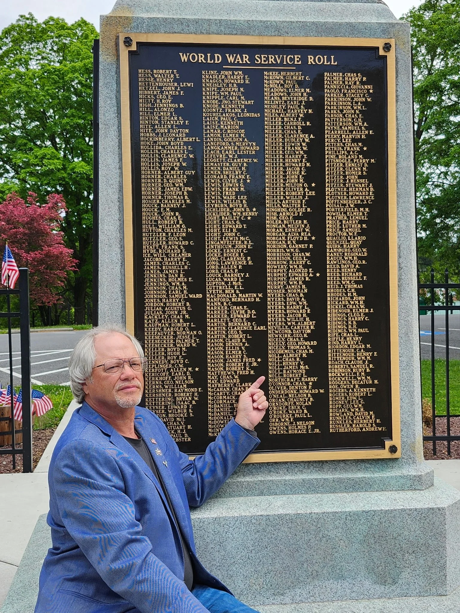 Brad Noll at War Memorial Park in Martinsburg, pointing at his grandfather's name.