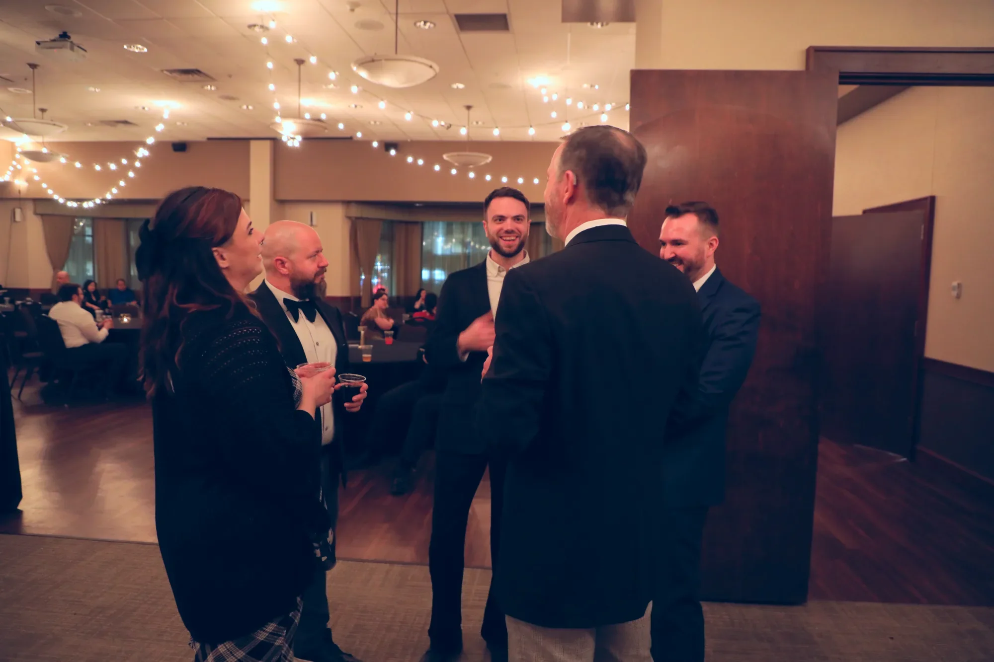 aqua-new-years-gala-2025-guests-mingling-near-resolutions-wall.webp