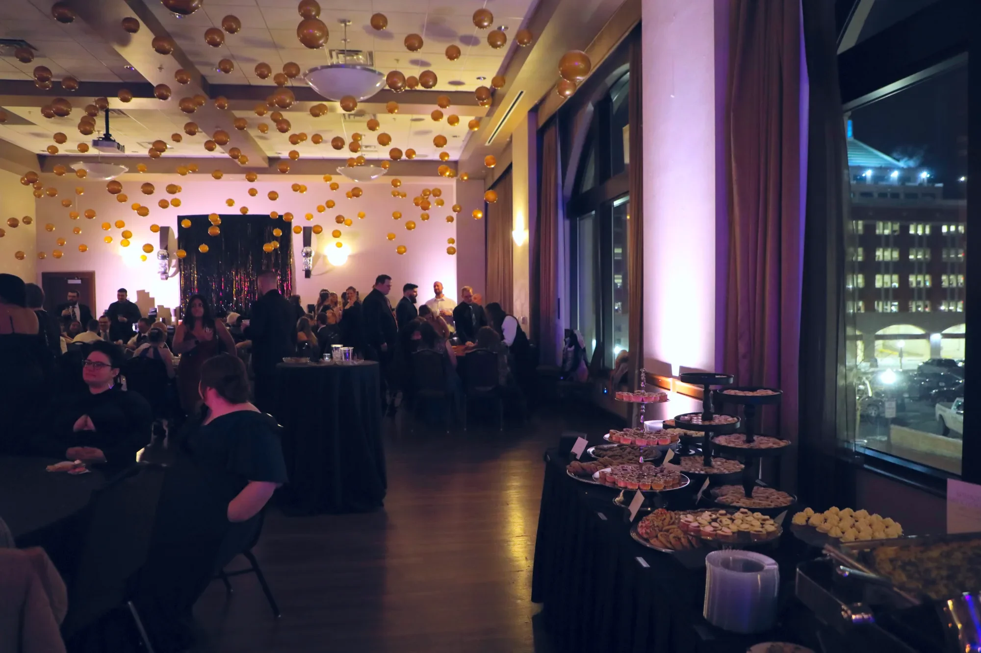 aqua-new-years-gala-2025-guests-mingling-by-windows.webp