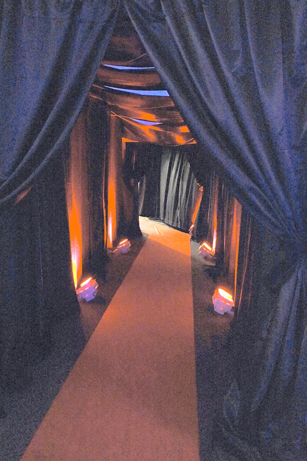 aqua-christmas-masquerade-2022-decor-entrance-corridor-black-drape.webp