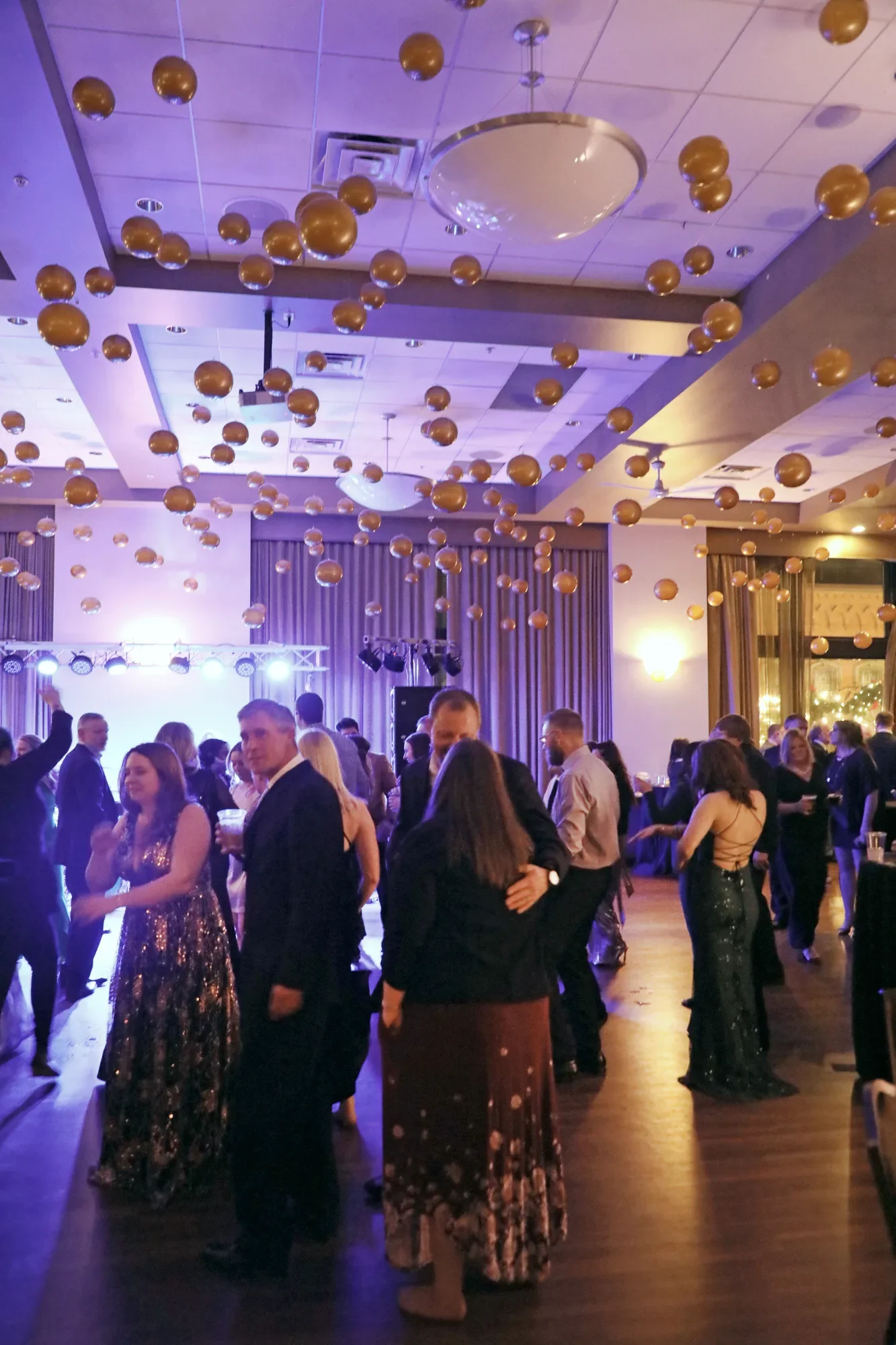 aqua-new-years-gala-2025-guests-late-night-mingling-blue-light.webp