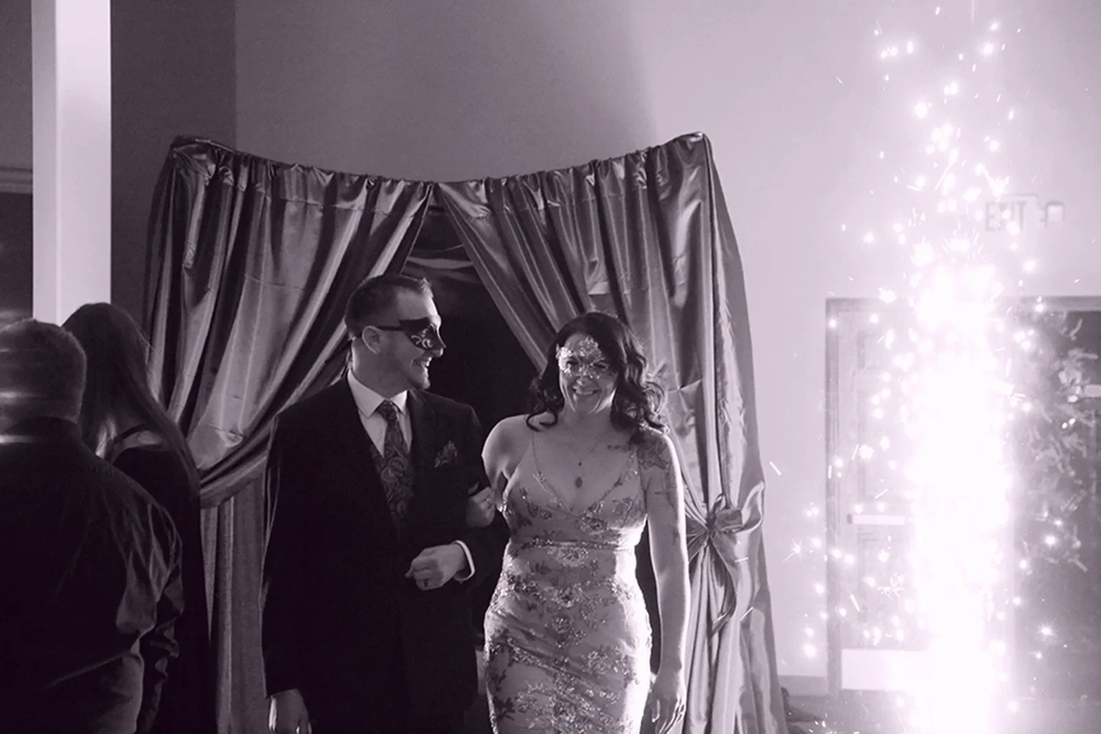 aqua-christmas-masquerade-2022-candid-grand-entrance-couple-walking-03.webp
