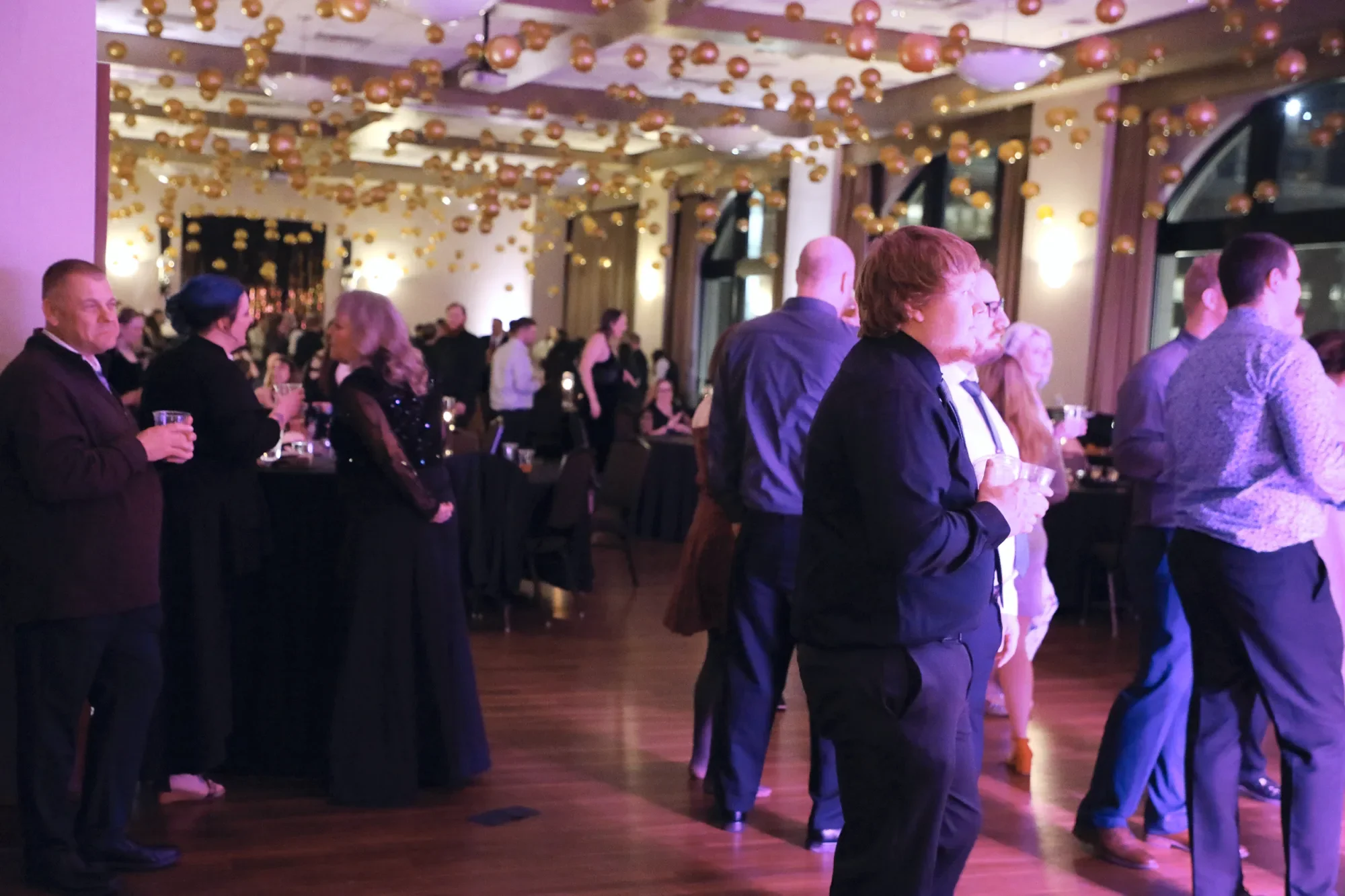 aqua-new-years-gala-2025-guests-pink-uplit-dance-floor-late.webp