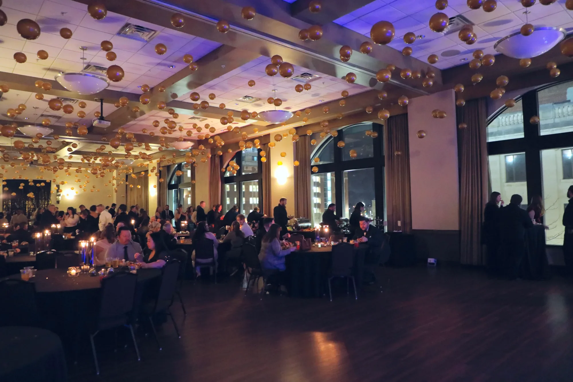 aqua-new-years-gala-2025-guests-cocktail-area-blue-light.webp