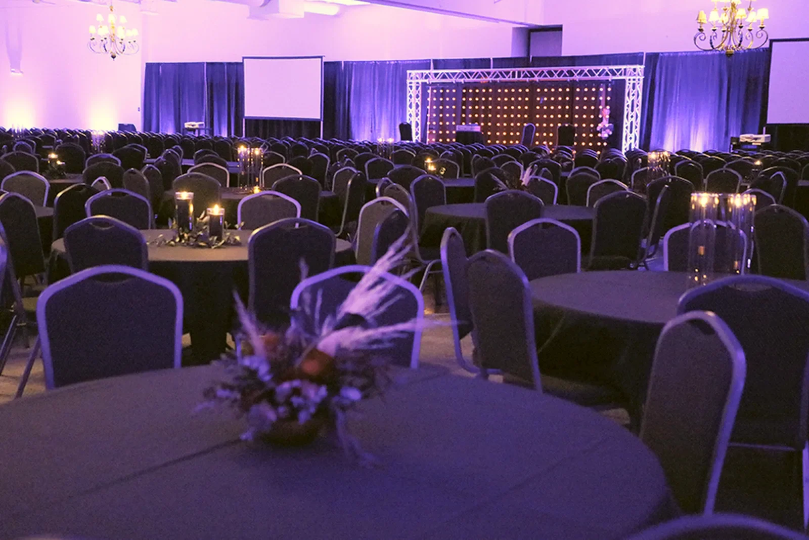 aqua-christmas-masquerade-2022-decor-ballroom-pink-uplit-with-stage.webp