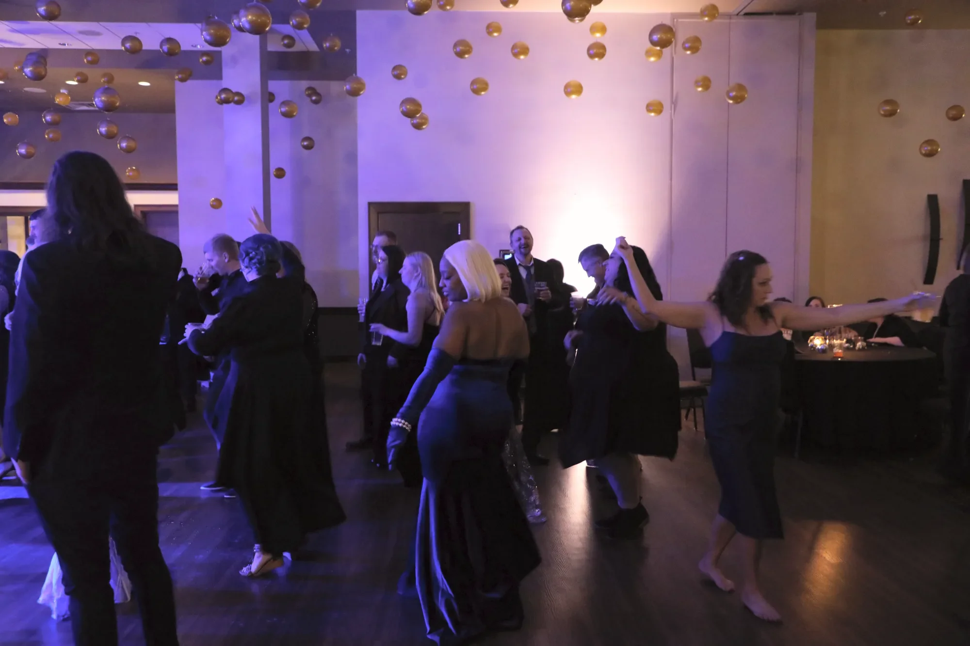 aqua-new-years-gala-2025-guests-mingling-pink-uplit-room.webp