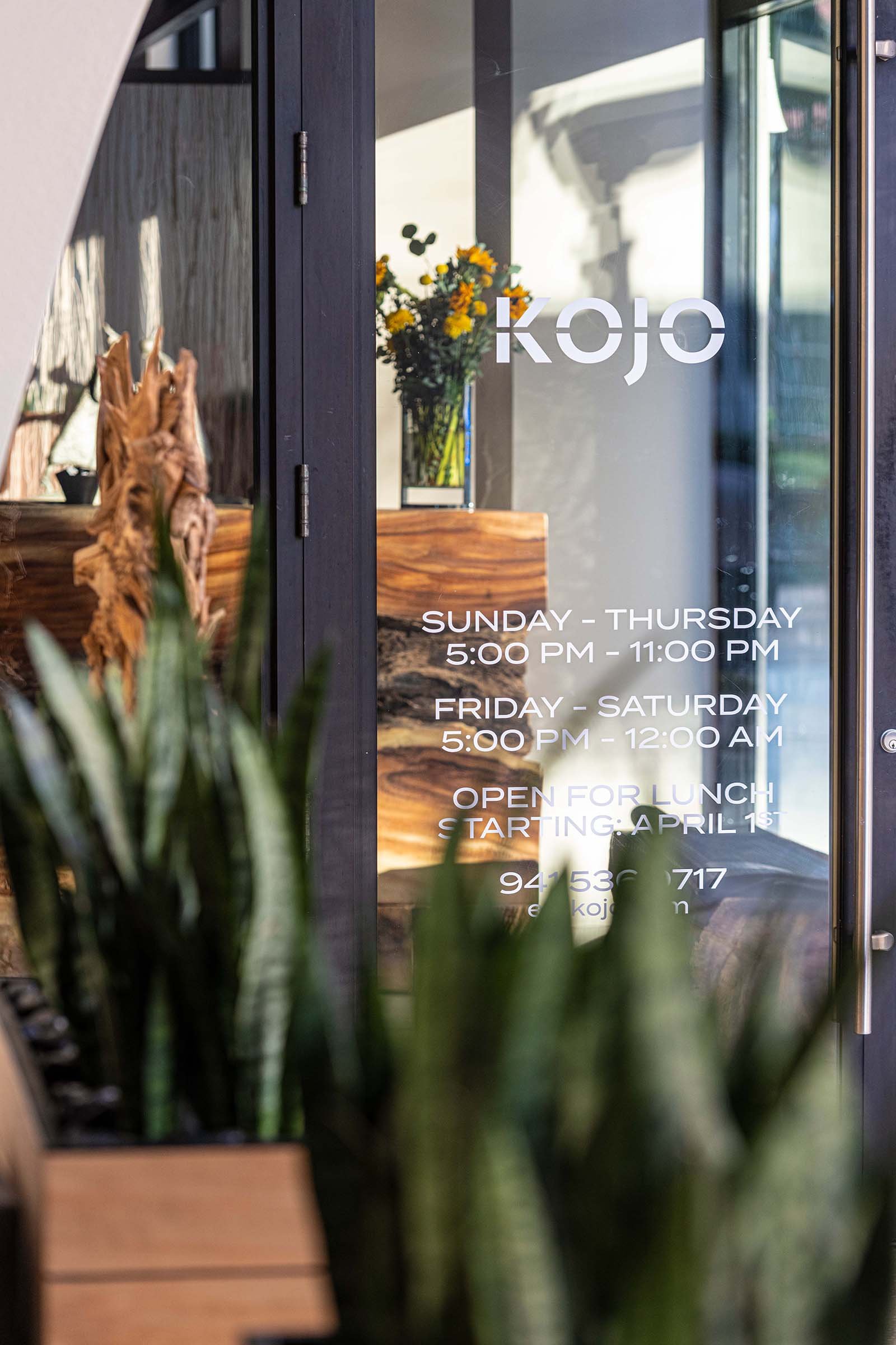 kojo+glass door+acacia wood+plants.jpg