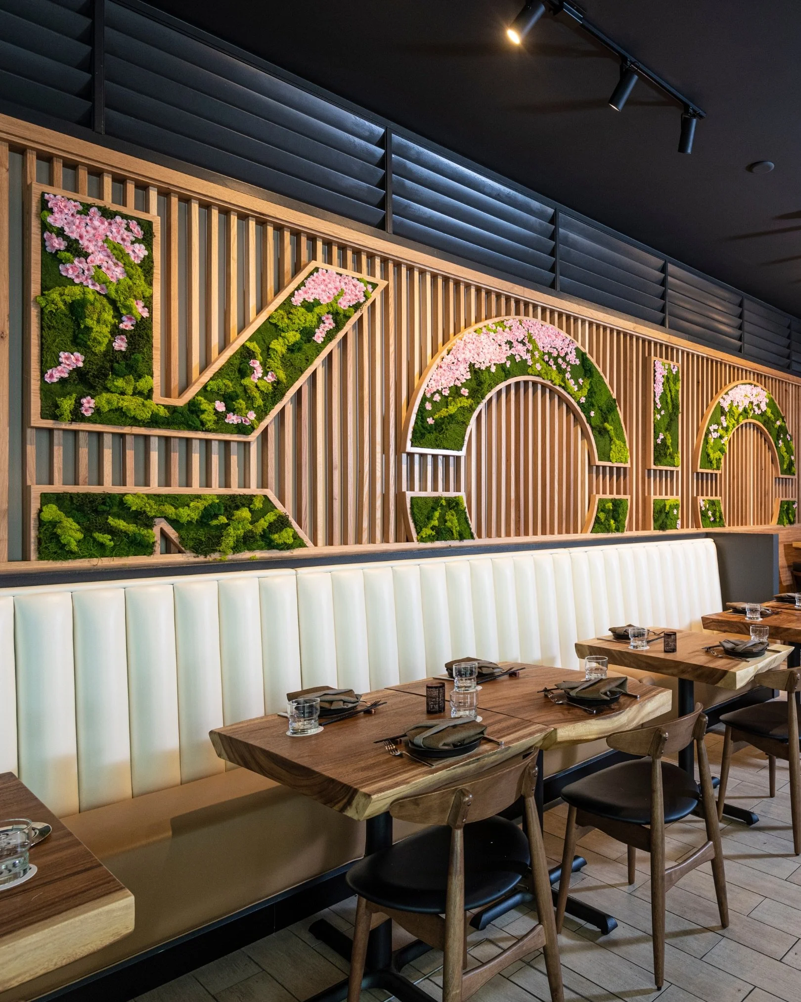 KOJO&rsquo;s design story began with a sculpture the owners discovered in an art gallery: two figures bowing to one another. The piece became the inspiration for the restaurant&rsquo;s interiors and now welcomes guests at the entrance.

Acacia wood s