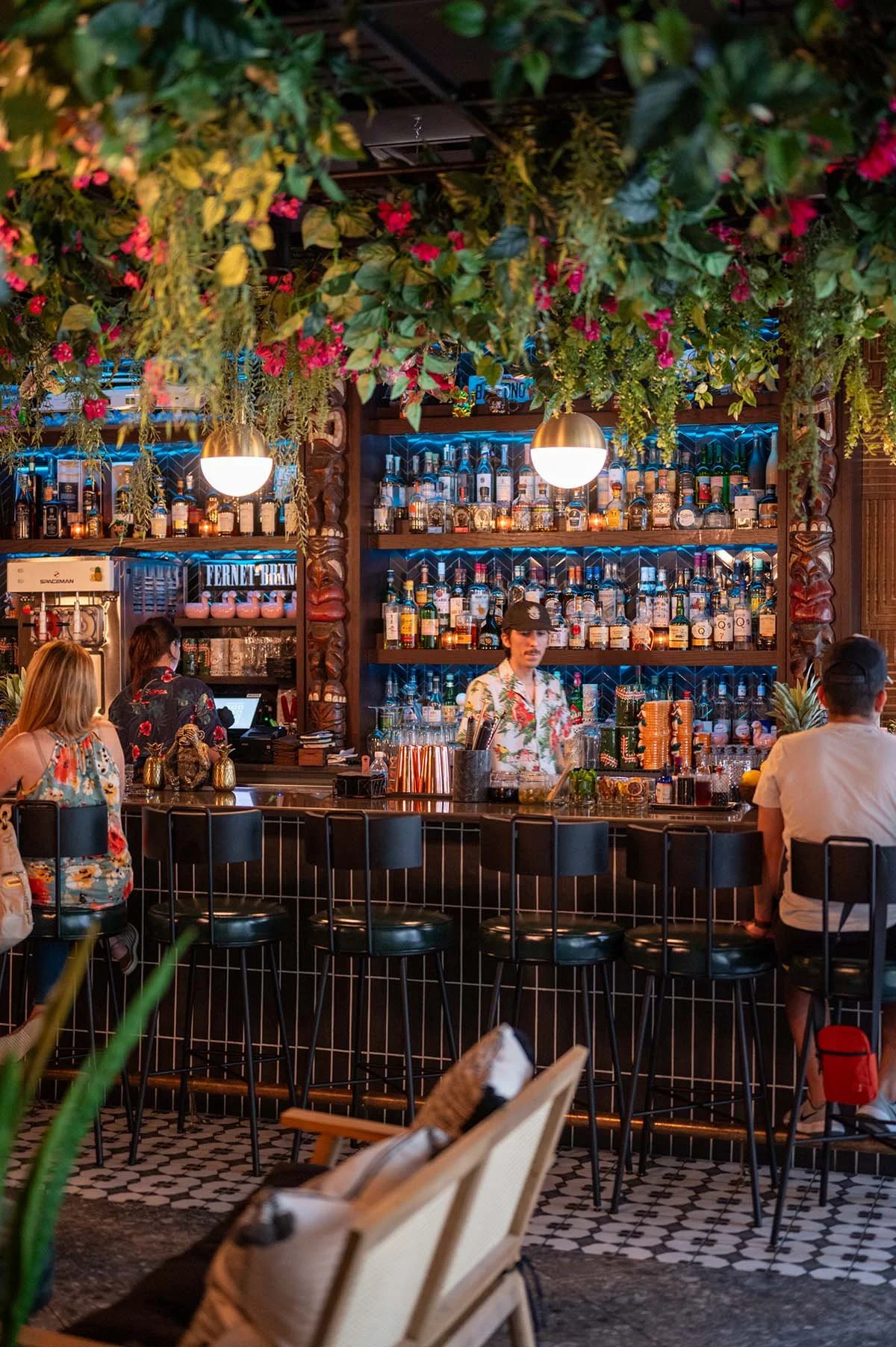 tropical bar+greenery+totem pole+bartender.jpg