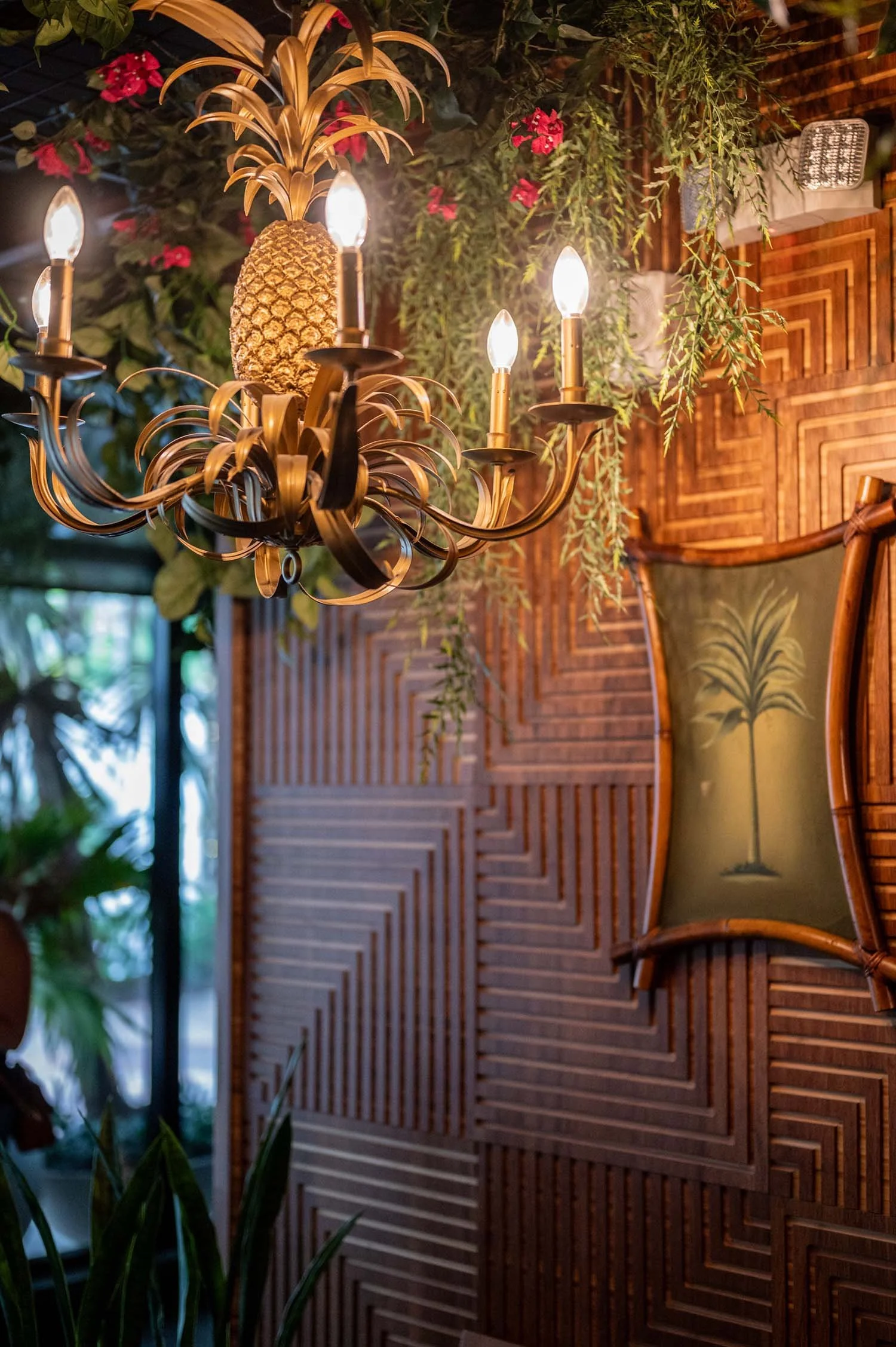 bamboo wall+pineapple light+gold chandelier+tropical bar.jpg