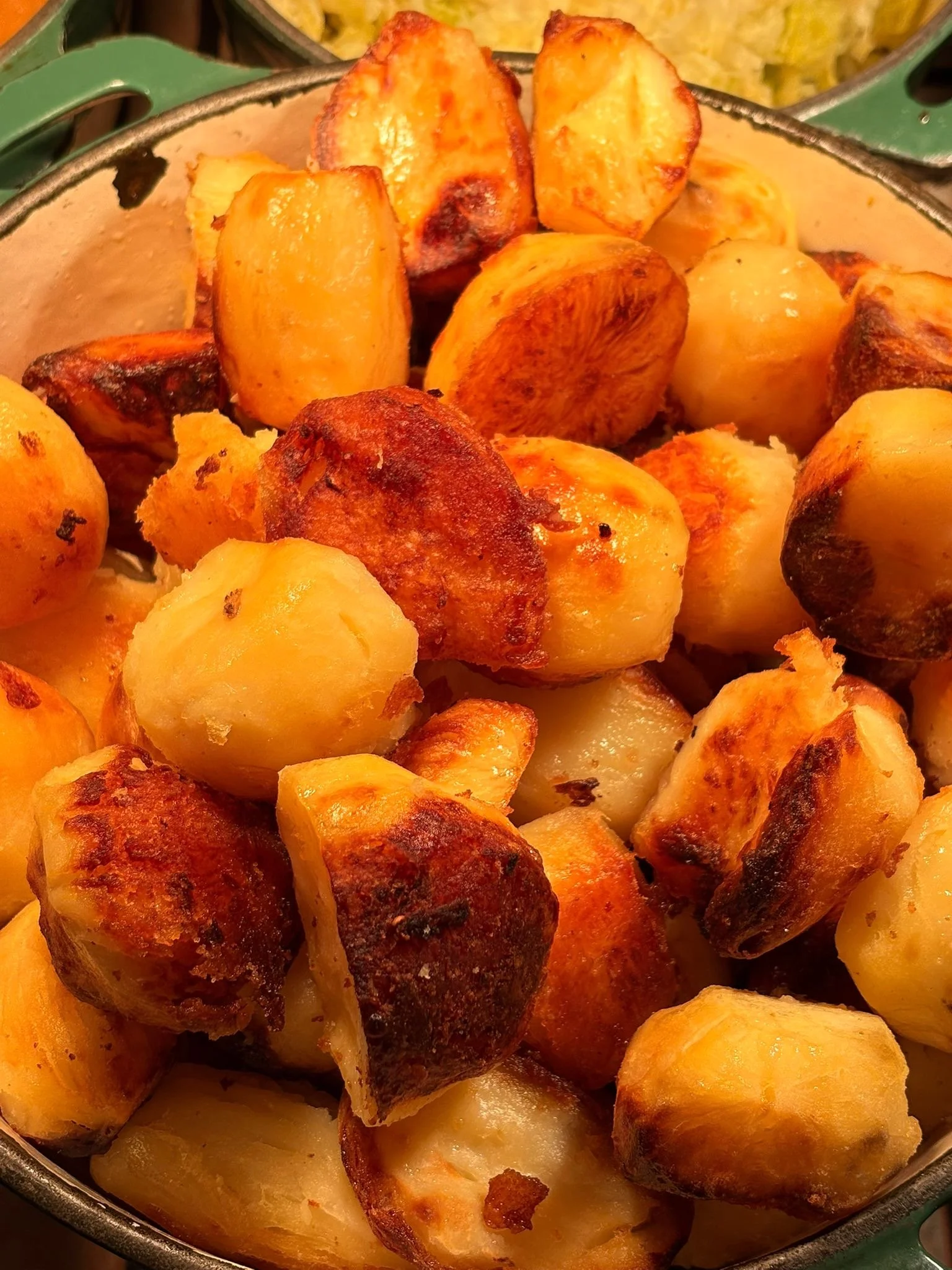 Roasted and crispy baby potatoes in a metal bowl.