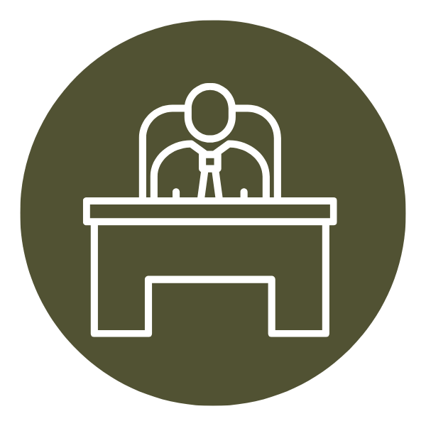 An outline of a person sitting at a desk, possibly a judge or official, wearing a tie, in a circular icon with a dark background.