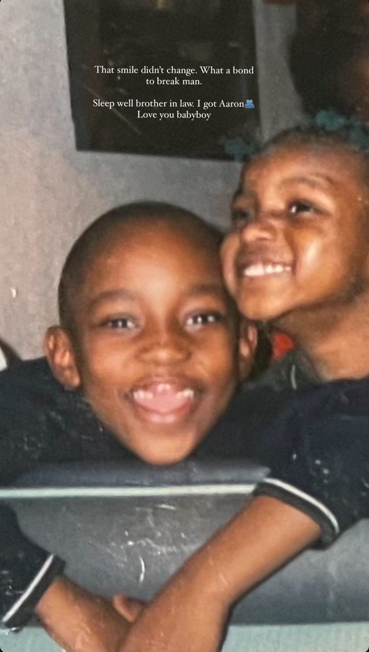 Two young kids smiling together.