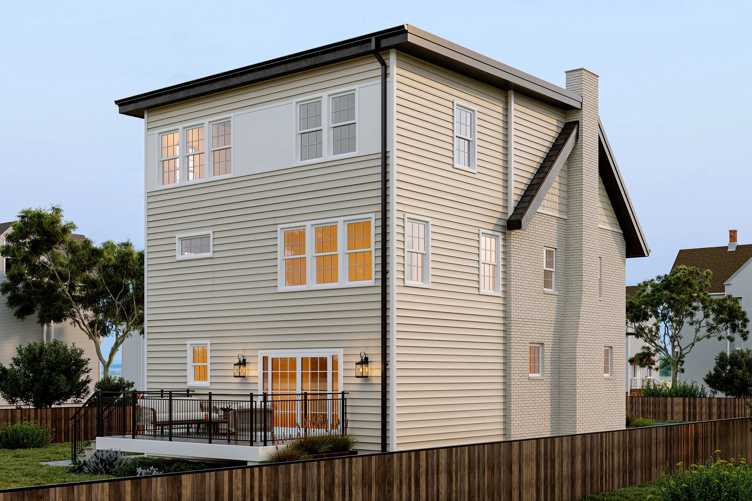 A modern, multi-story house with beige horizontal siding, multiple windows with white trim, and a brick chimney. The porch has black railing, seating area, and outdoor lighting, with a fenced backyard and trees around.