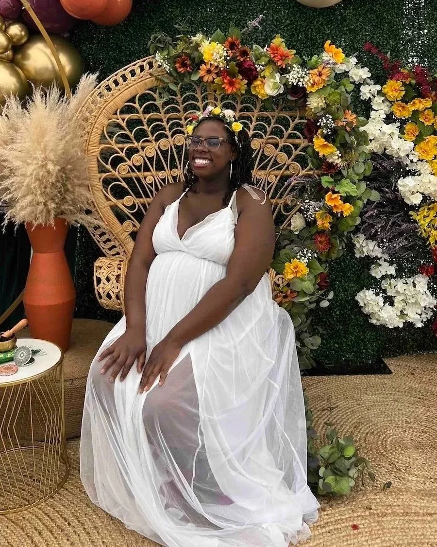 Photo of pregnant Black woman sitting