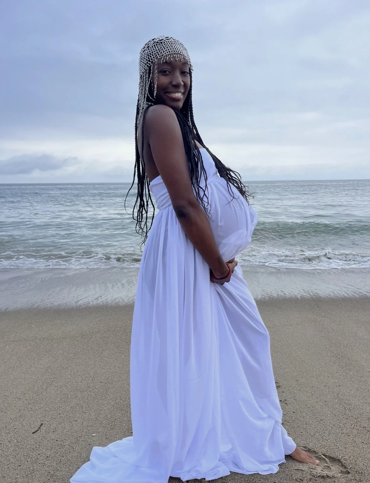 Photo of pregnant Black woman on the beach