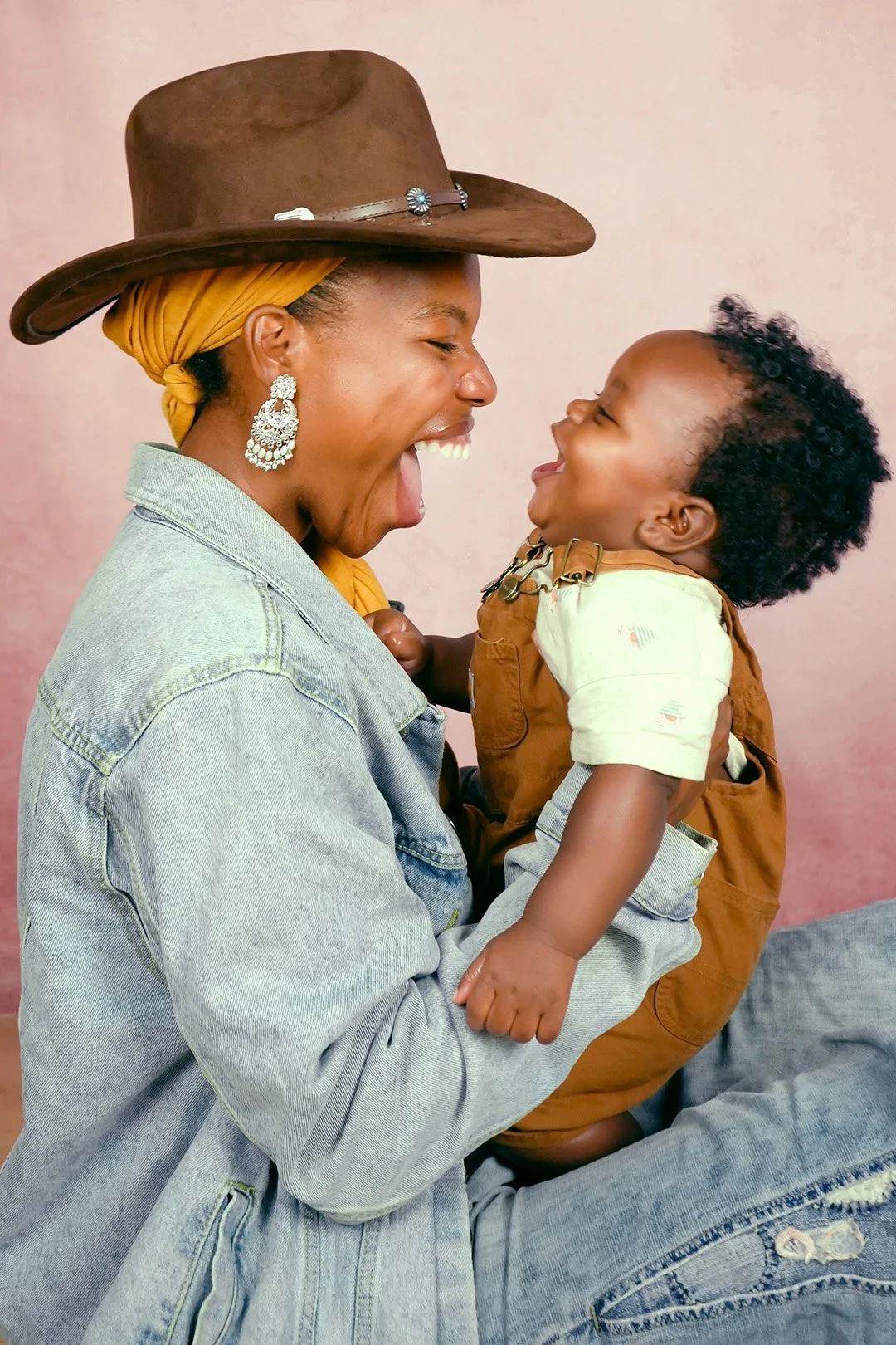 Photo of smiling Black woman with happy baby