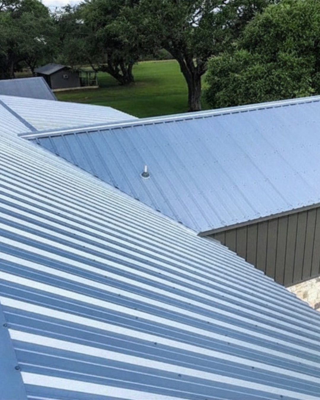 Multiple gable metal house roof. Galvalume (Silver) PBR Panel. Project location is Cuero Texas