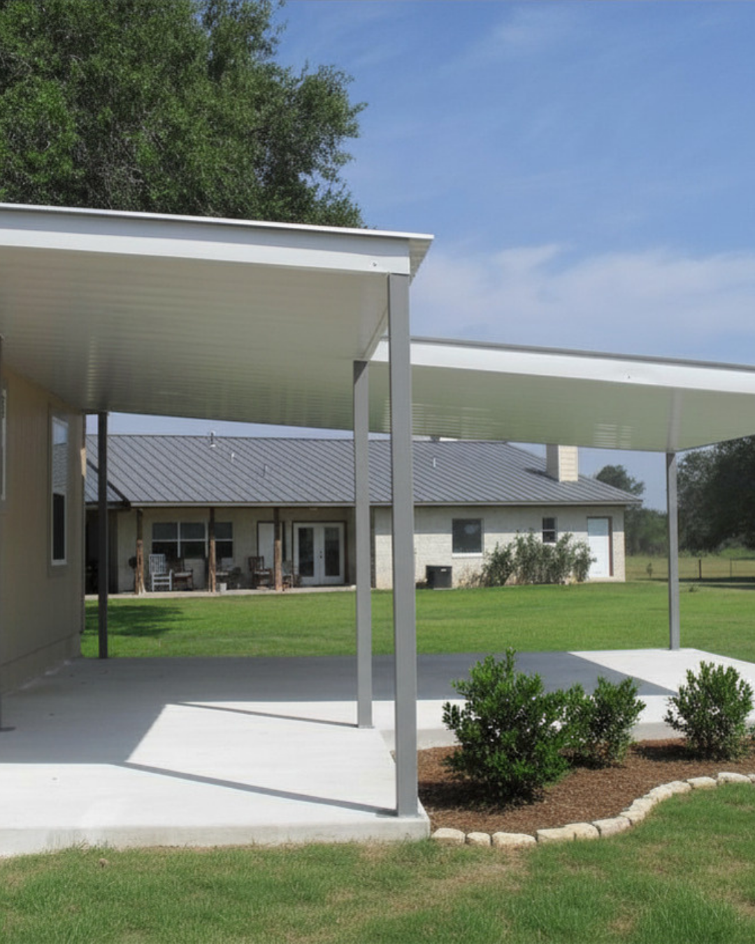 Welded steel carport and patio combo with square tubing columns. White custom metal trim and flat panel soffit panels