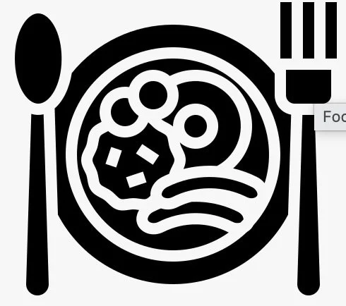 Plate of food with noodles, vegetables, and possibly meat, with a spoon on the left and a fork on the right.