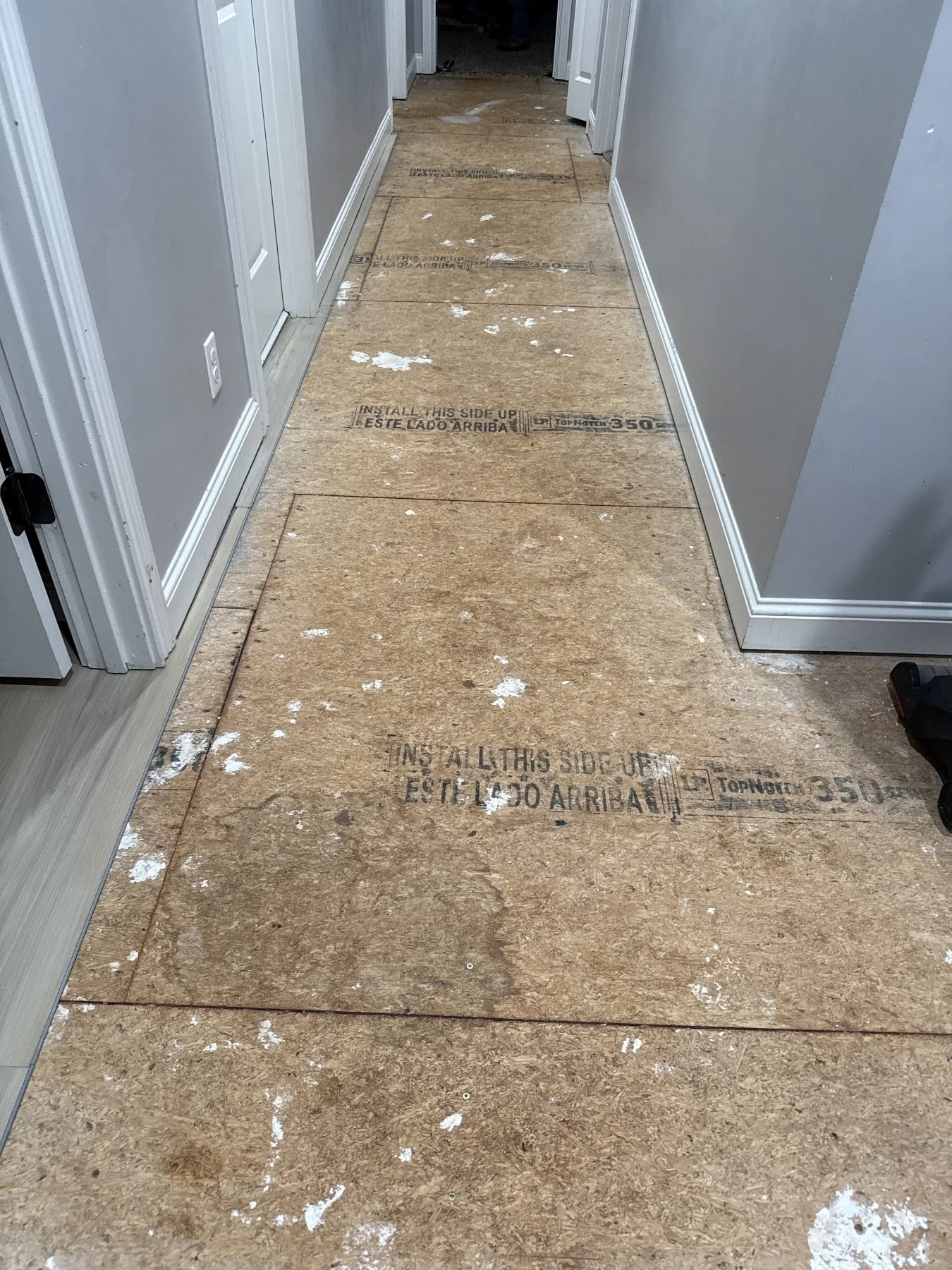New laminate flooring installation in a hallway for a military PCS move-out in Clarksville, Tennessee.